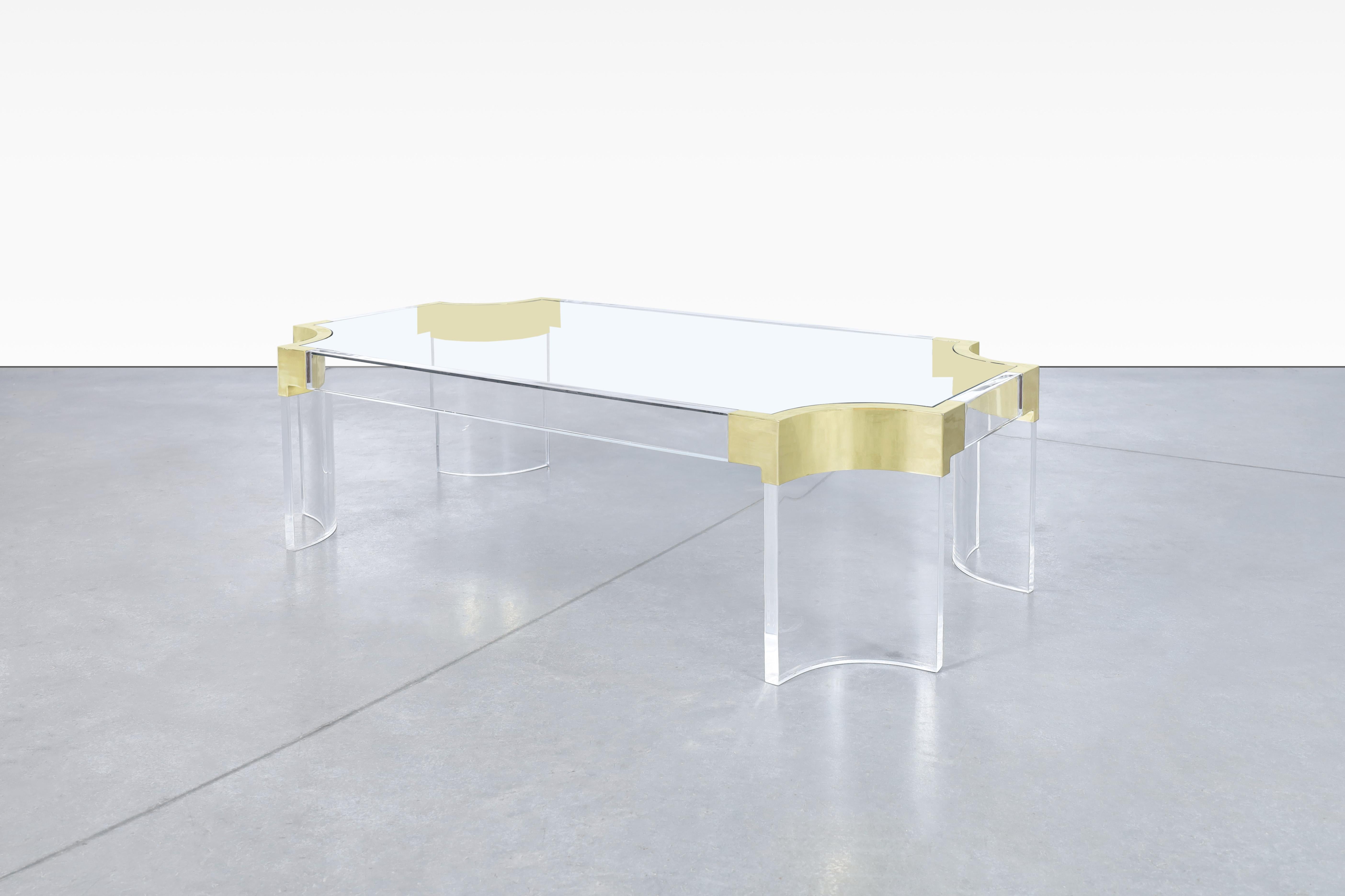 Stunning mid-century brass and acrylic “Inner-Waterfall” coffee table designed by Charles Hollis Jones and manufactured in the United States, circa 1970s. This exquisite table boasts a unique design that showcases the artistic flair of the legendary