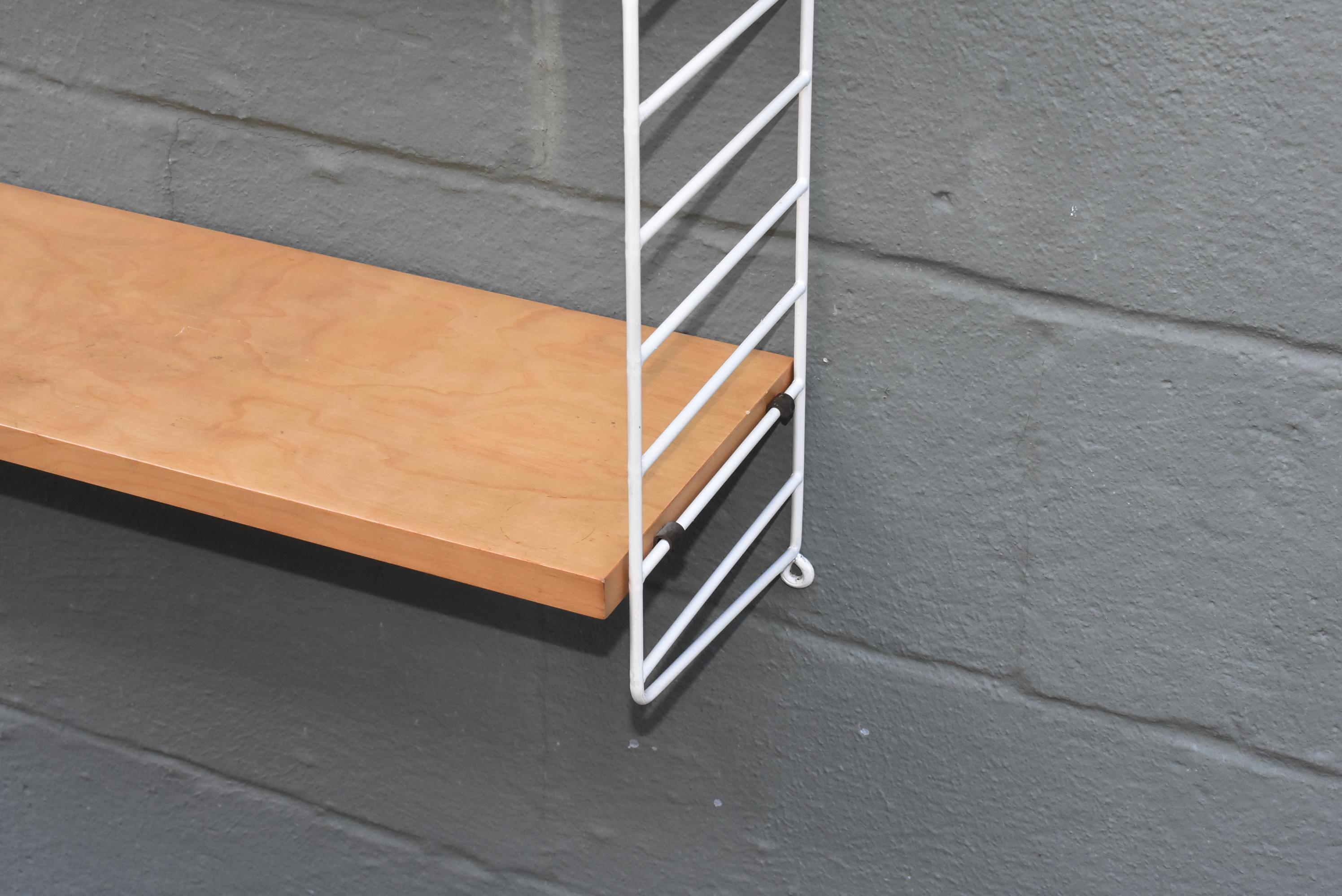 Mid-Century Modern adjustable birch and coated wire ladder wall shelves made in Sweden, circa 1960s. Size: 39