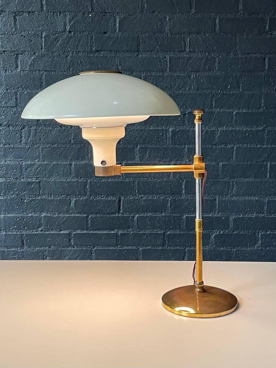 Condition: Original Vintage Condition
Designer: Dazor Manufacturing Corp. 
Manufacturer: Dazor Manufacturing Corp. 
Materials: Brass, Steel Chrome, Enameled Metal, Perforated Brass Diffuser 

This adjustable desk lamp by Dazor Manufacturing Corp.