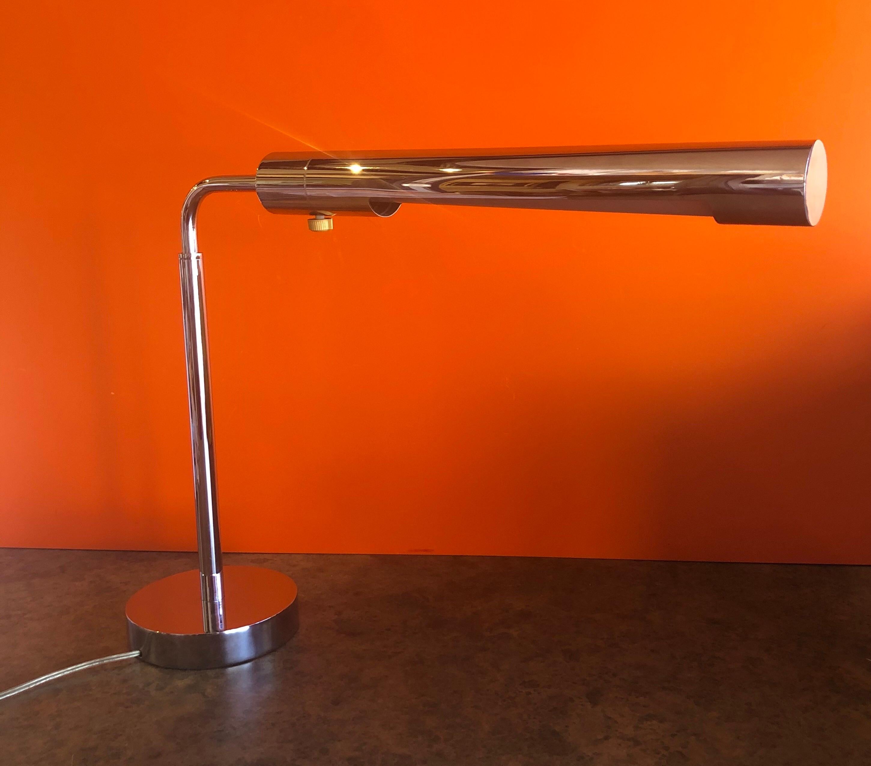 A very nice midcentury adjustable chrome pharmacy desk lamp with elongated shade in the style of Koch & Lowy, circa 1960s. The telescoping lamp can adjust from height of 15.25