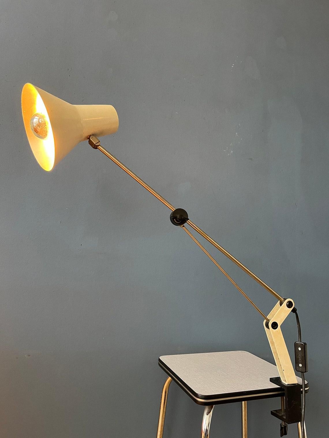 Mid century adjustable clamp desk lamp. The shade can easily be adjusted, as well as the height/length of the frame. It requires an E27/26 lightbulb and currently has an EU-plug (works outside EU with plug-converter).

Additional
