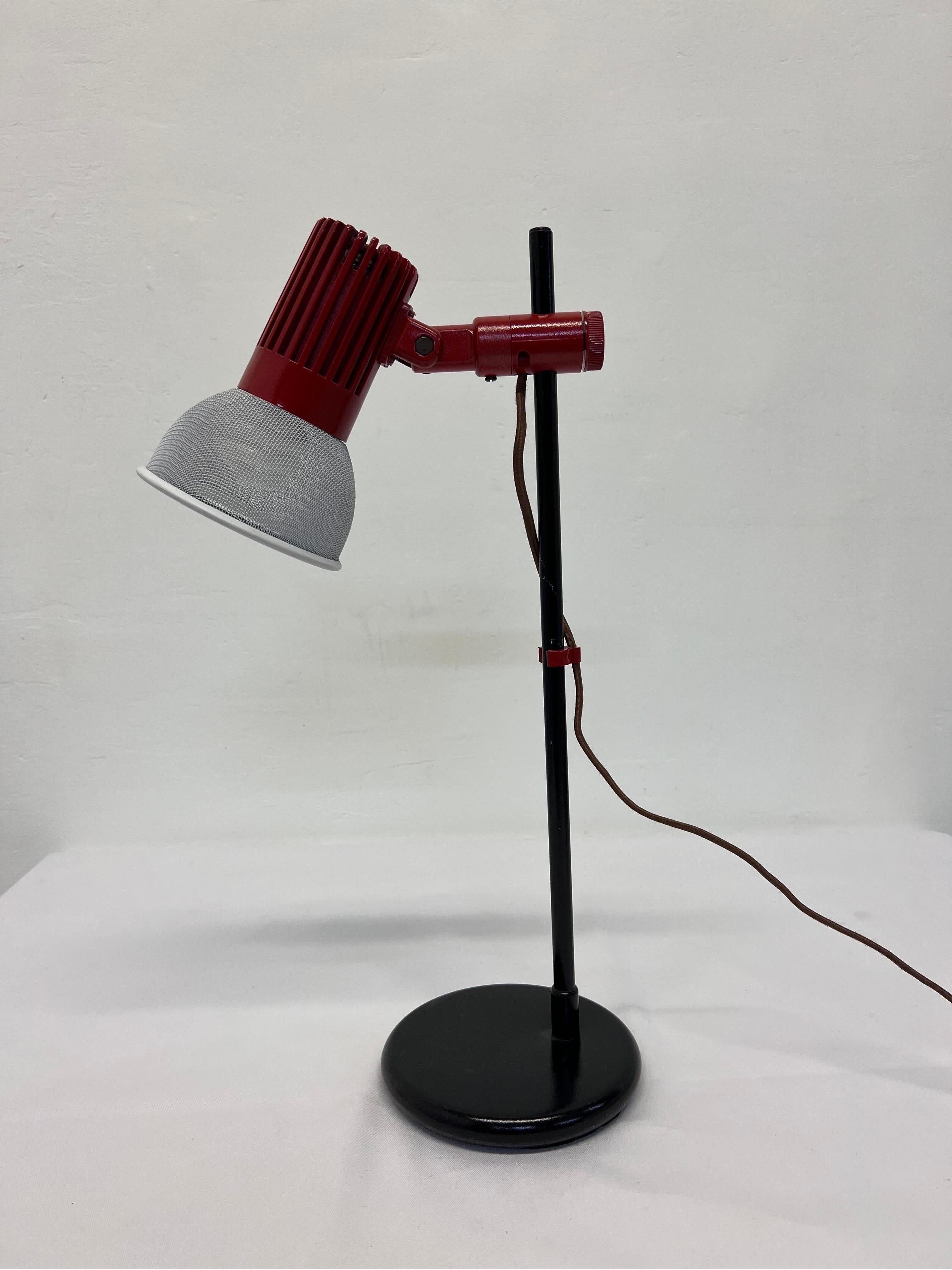 Mid-century red, black and white desk or table lamp with adjustable height and multi-directional perforated shade by Unilite International. Cord is for US outlets and has an in-line on/off switch.