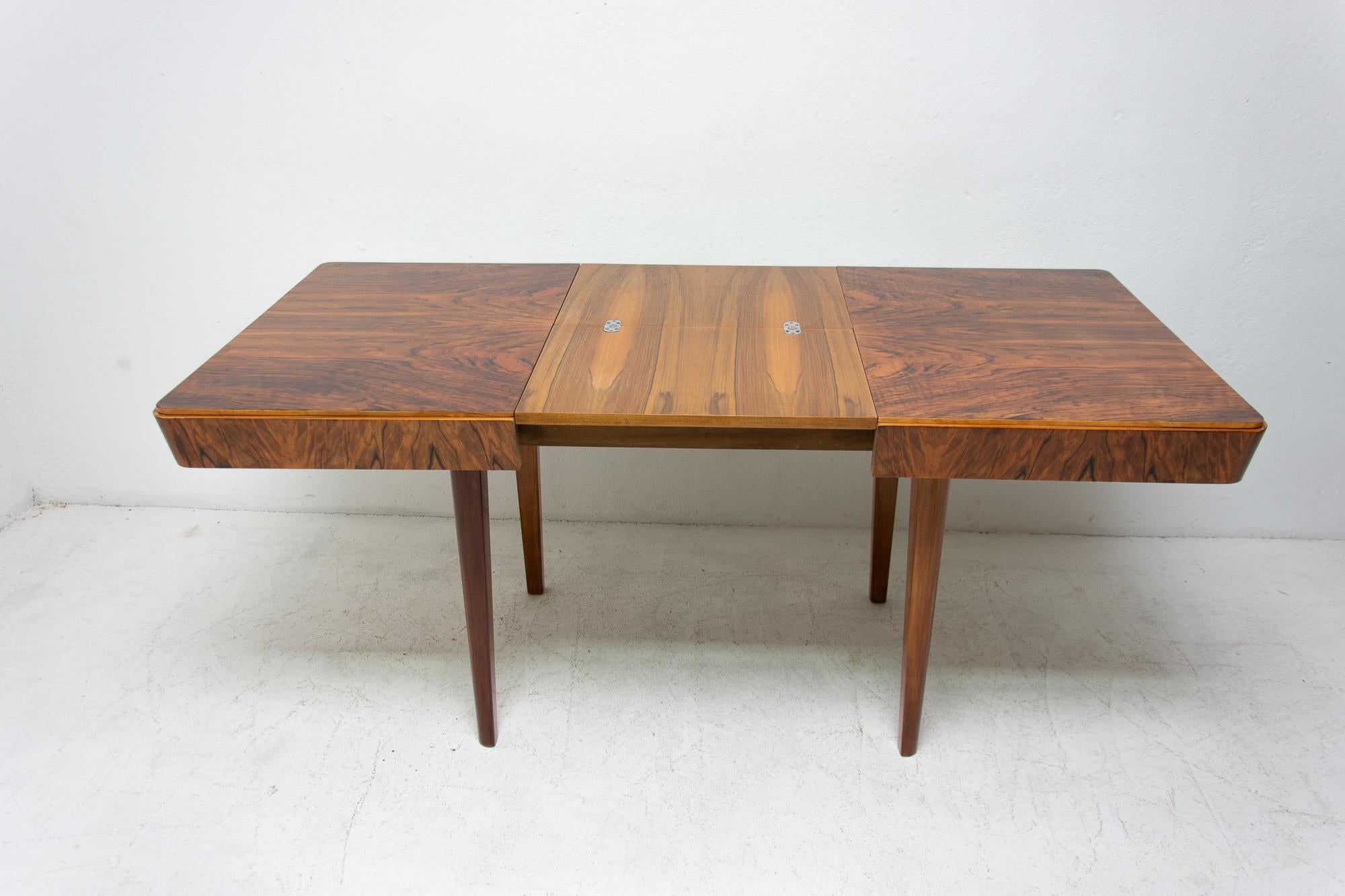 This adjustable dining table was designed and made in the 1950s in the former Czechoslovakia. It was designed by Jindřich Halabala. The material is a combination of solid wood and walnut veneer. It was professionally restored. The wood has been