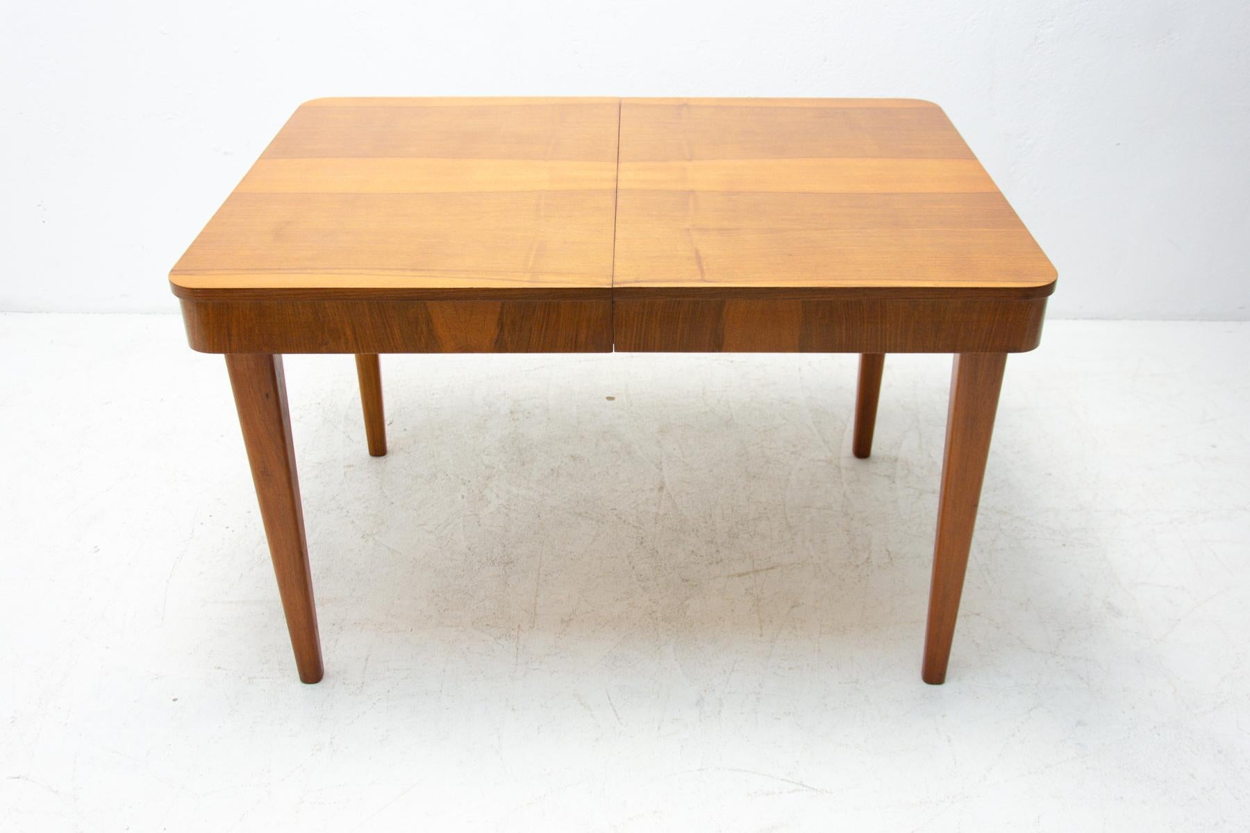 This adjustable dining table was designed and made in the 1950s in the former Czechoslovakia. It was designed by Jindrich Halabala for ÚP Závody Brno. The material is a combination of solid wood and walnut veneer. The table is in very good Vintage