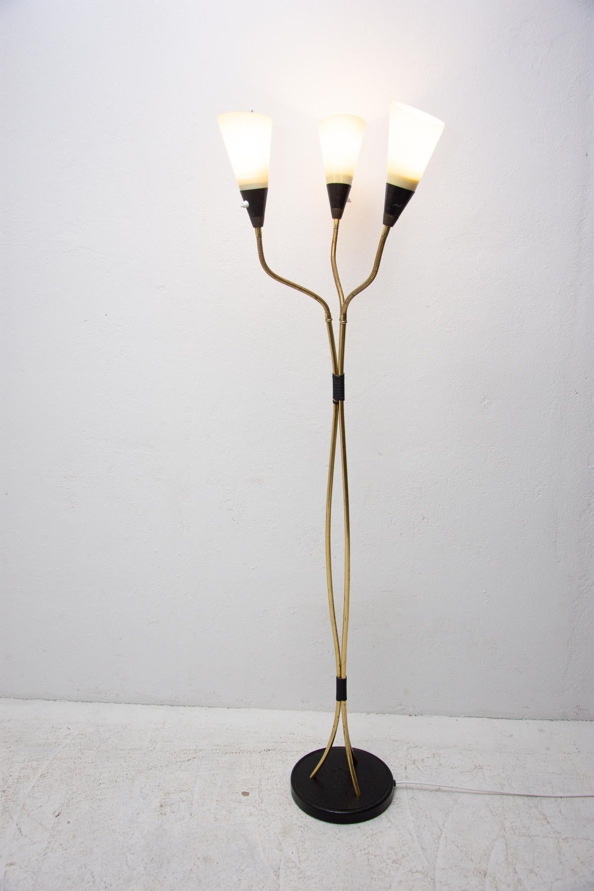This standing lamp is a typical example of Czechoslovak lightings from the mid century associated with “Brussels period” and world-renowned EXPO58. Nickel-plated construction, three frosted glass lampshades. New wiring. It´s possible to adjust the