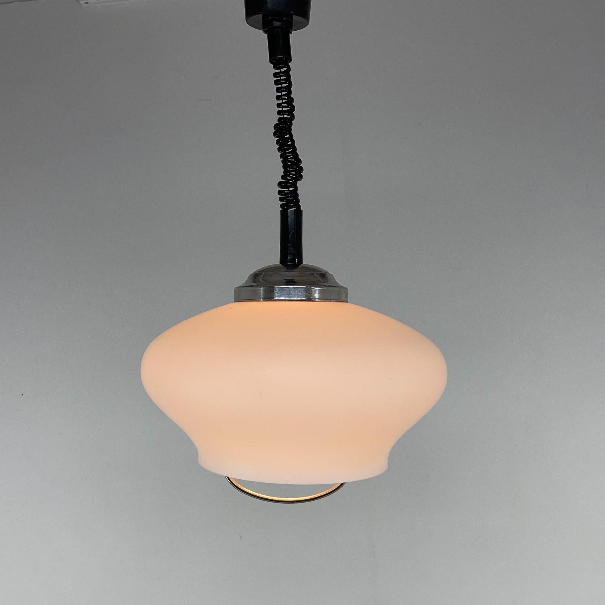 Vintage pendant light made of milk glass. The height is adjustable and it stretches up to 120 cm. There is a tiny chip on the glass (see photo). Overall the pendant is in good vintage condition.