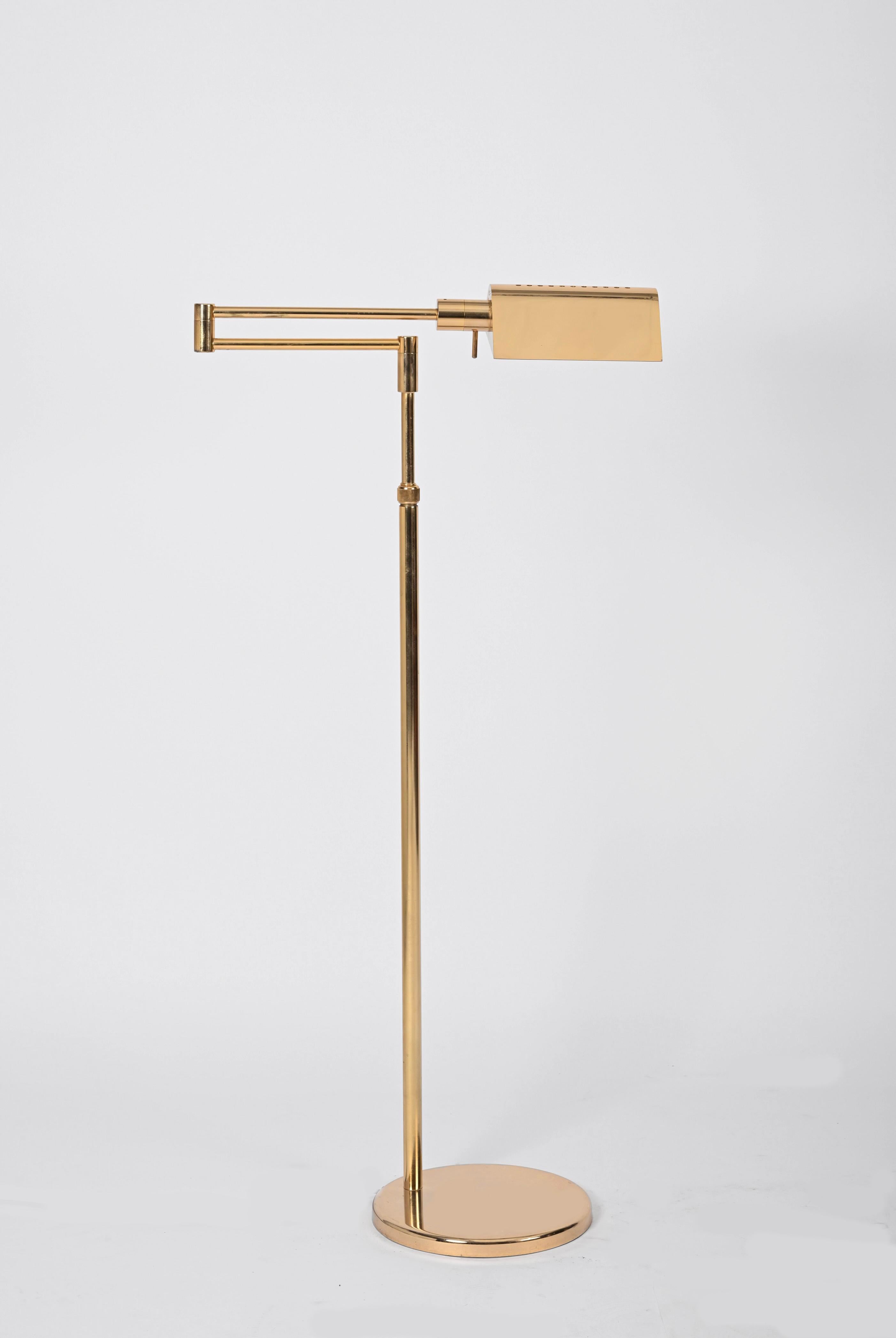 Gorgeous midcentury adjustable floor lamp in gilded brass. This stunning lamp is signed on the light switch by Gianfranco Frattini and was produced in Italy during 1970s. 

This elegant floor lamp is fully adjustable in height along the body and