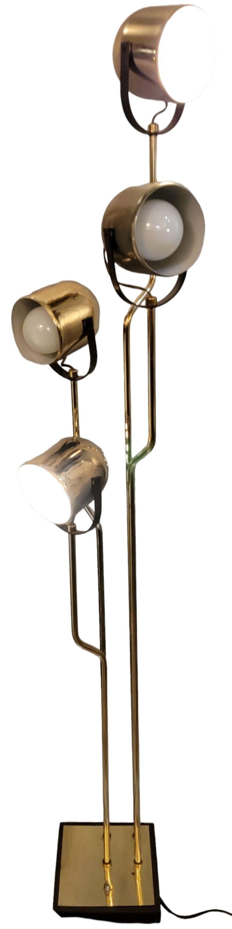 Vintage Italian brass Goffredo Reggiani Four Light Floor Lamp . Each light is adjustable and may be pointed  turned 360 degrees side ways and Just over 180 degrees upward. Measures  approx - 12 x 12 x 65 at longest points. Wear due to age has