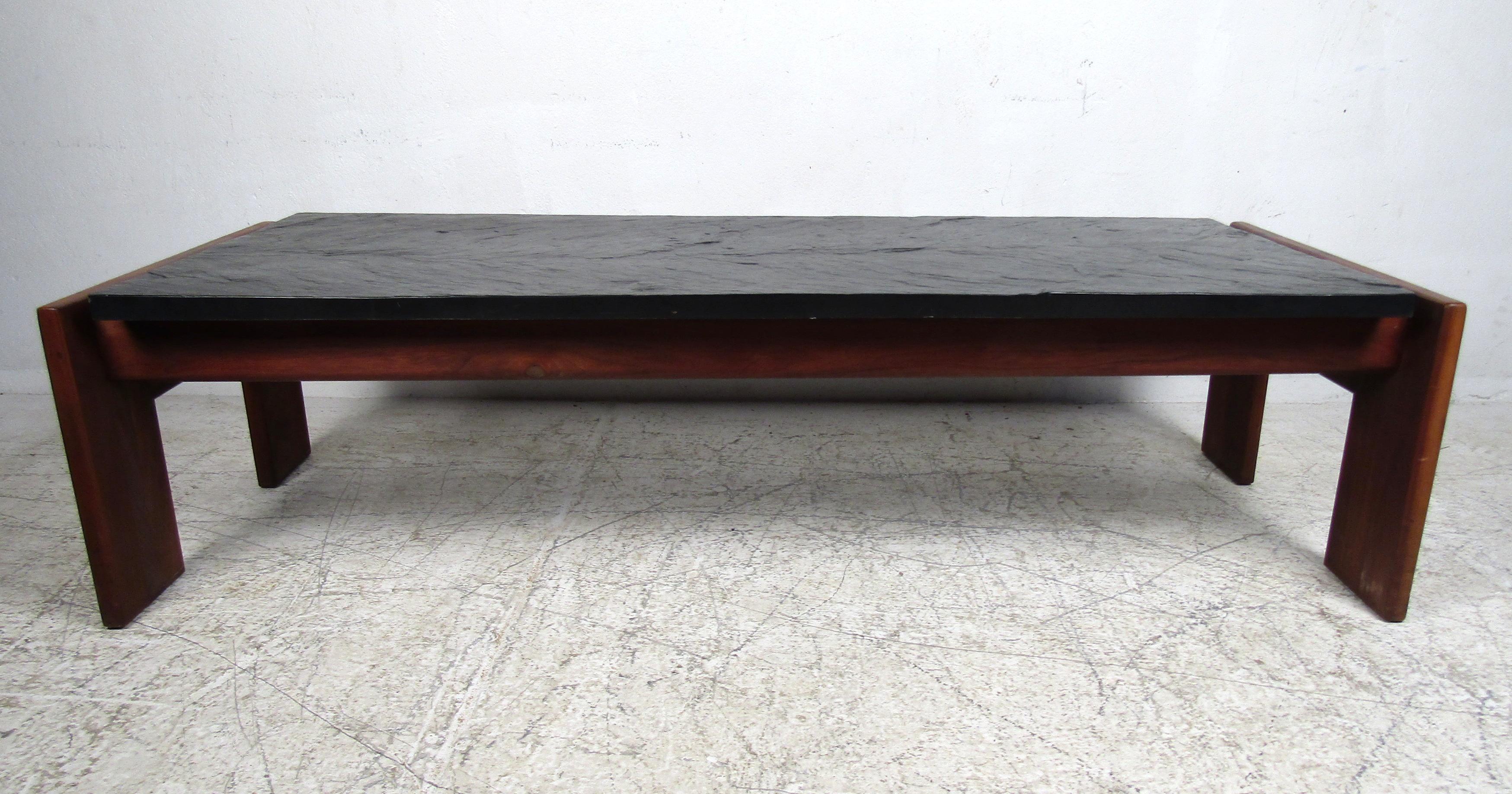 Vintage modern slate top coffee table featured in rich walnut grain by Adrian Pearsall.

Please confirm the item location (NY or NJ).
        