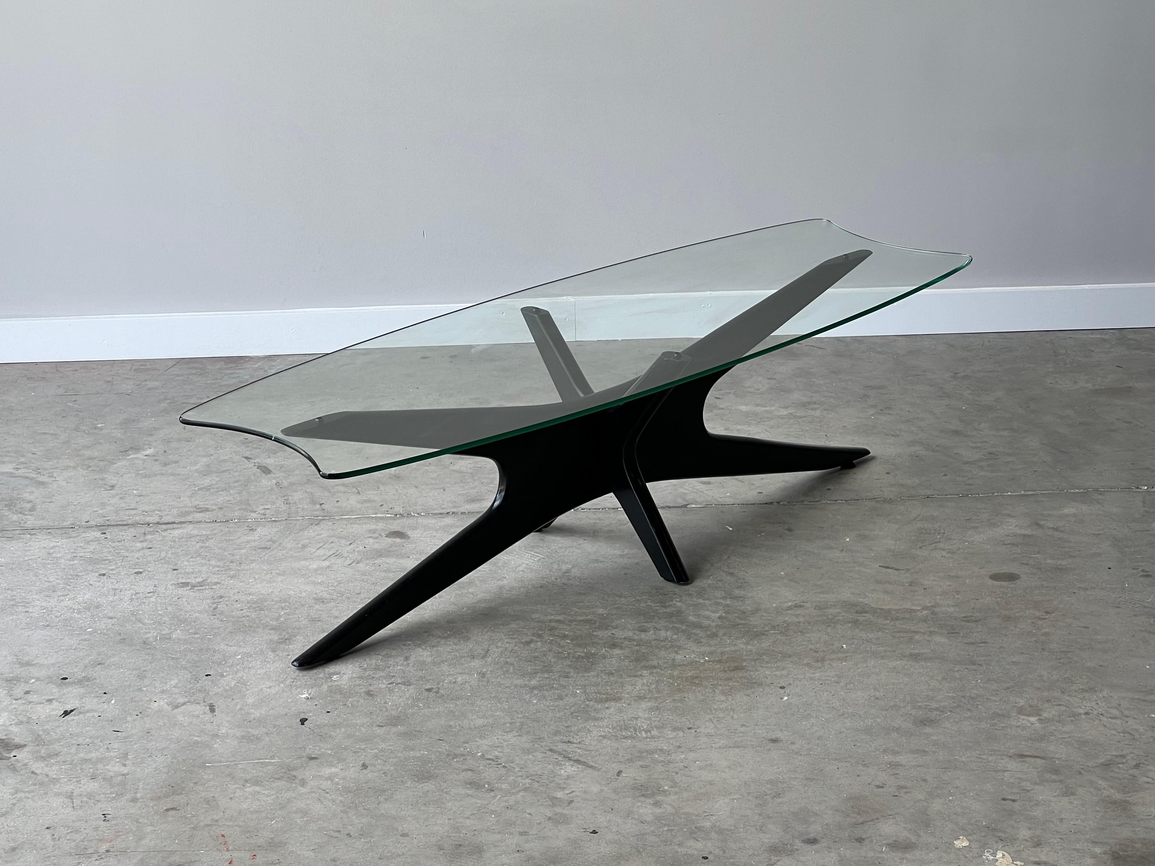 Elegant black lacquered coffee table. Designed by Adrian Pearsall and named the “Jacks” coffee table. The stingray glass top is original with curved end details that make the piece more visually interesting. In overall fantastic vintage condition