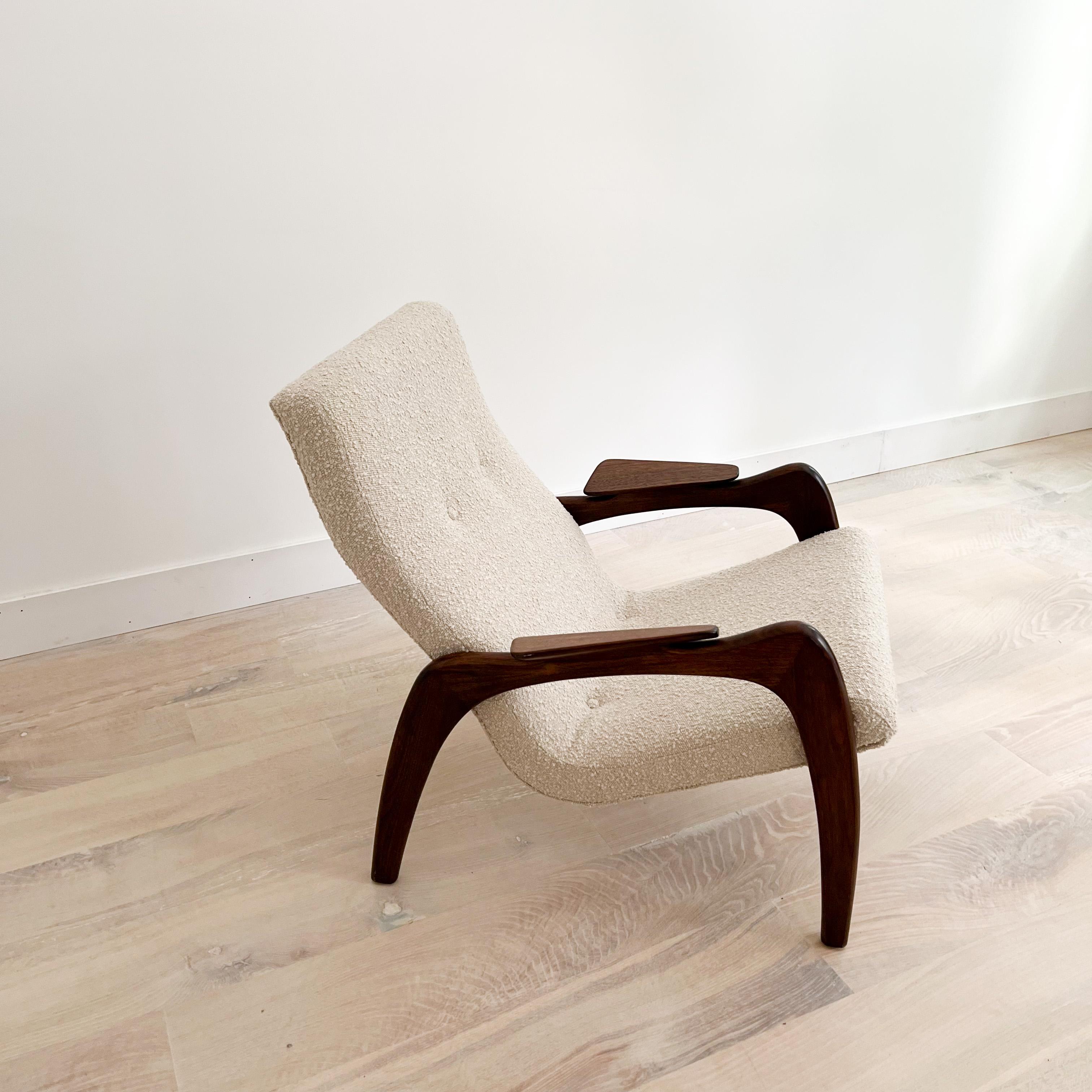 Mid-Century Modern scoop lounge chair with sculpted solid walnut frame designed by Adrian Pearsall for Craft Associates. New foam and oatmeal toned boucle upholstery. Some light scuffing/scratching to the walnut frame but overall good condition.