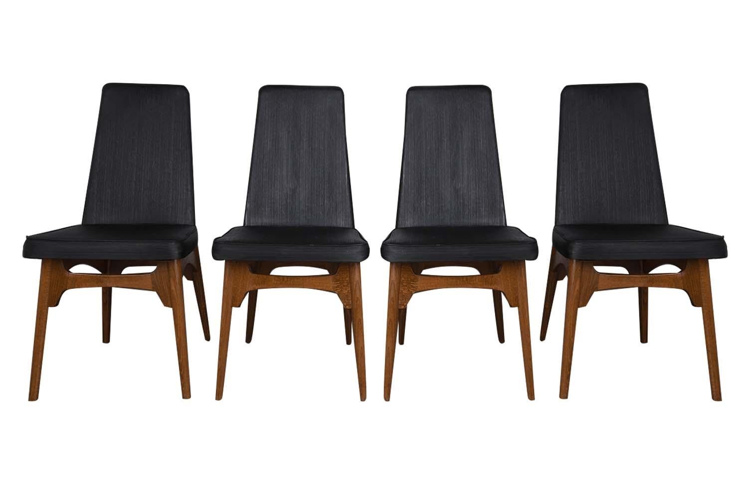 An outstanding set of four beautiful midcentury Adrian Pearsall style dining chairs with walnut frames and black upholstery, circa 1960s. Organic and functional aesthetic are showcased in these beautifully crafted modern walnut dining chairs. These