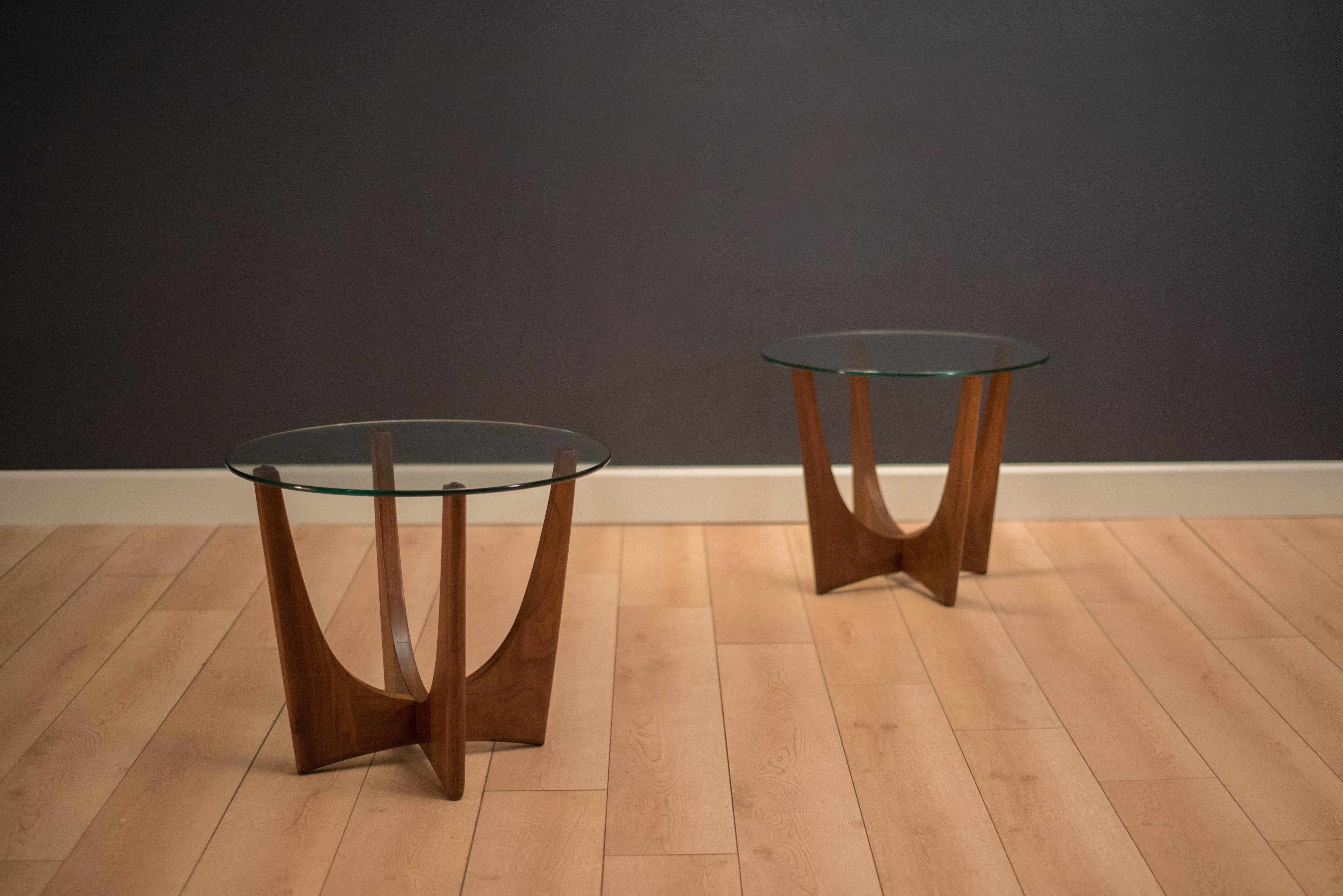 Mid-Century Modern pair of side tables designed by Adrian Pearsall for Craft Associates. This set is made of solid sculpted walnut with a round glass top. Price is for the pair.