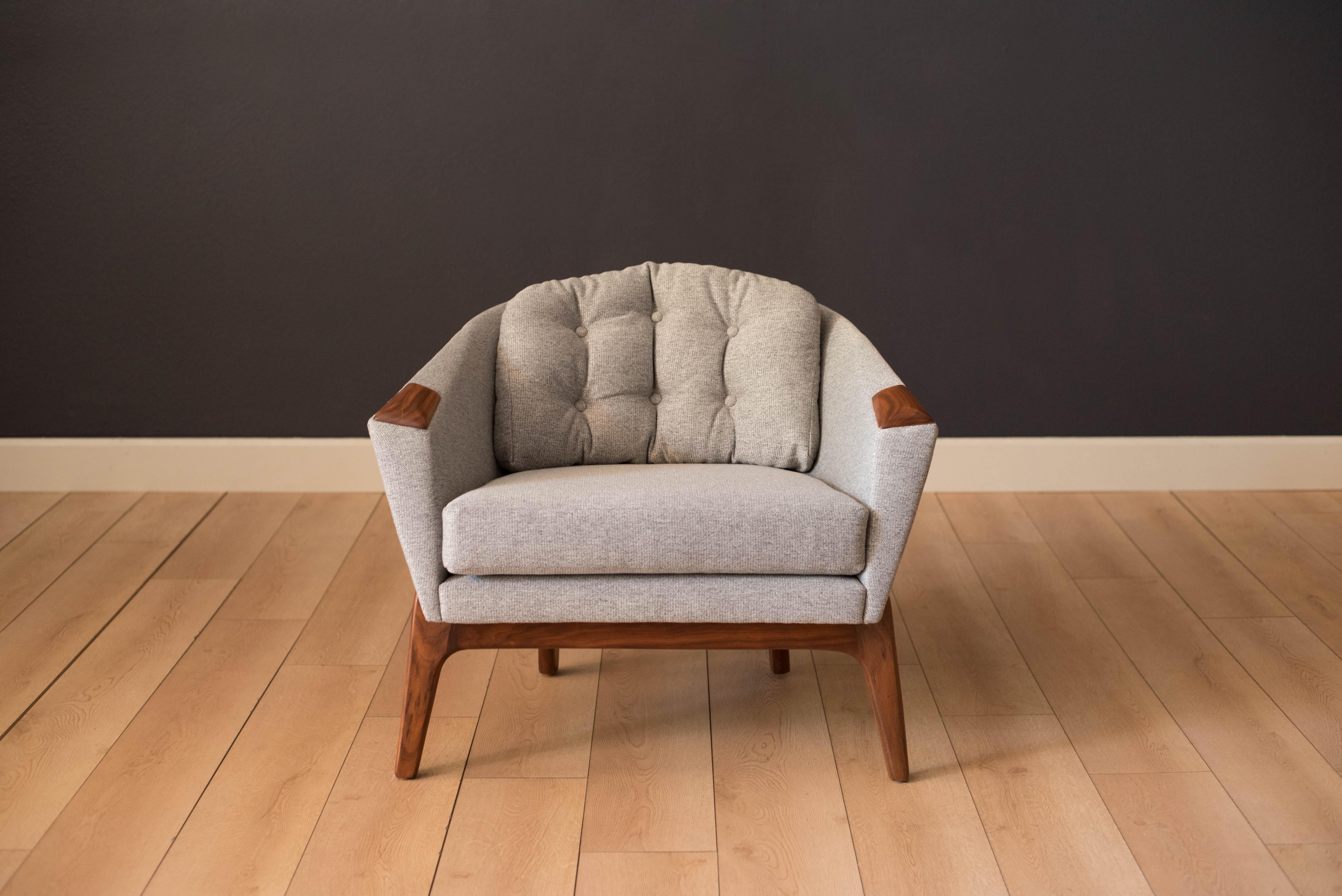 Vintage armchair designed by Adrian Pearsall for Craft Associates. This piece features walnut accent arms and a solid sculptural base. Reupholstered with new foam and fabric in a tufted grey tweed.


Offered by Mid Century Maddist