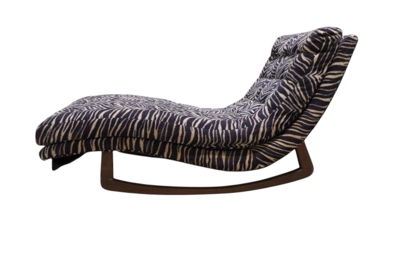 This wave rocking lounge chair by Adrian Pearsall is a standout piece of sculptural mid-century design. With its flowing, contoured silhouette and solid walnut rocking base, it’s built for comfort and movement—ideal for relaxing, reading, or just