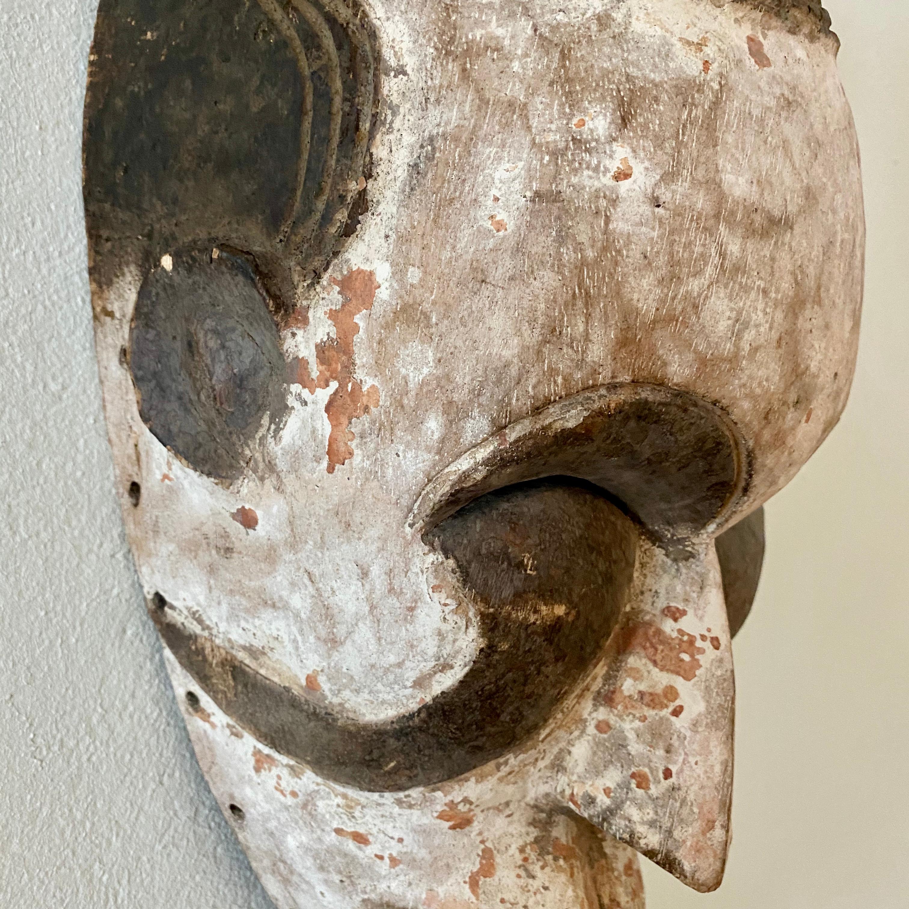 Mid-20th Century Midcentury African Kpelie Mask Senufo Tribe Ivory Cost with a Calao Bird, 1950