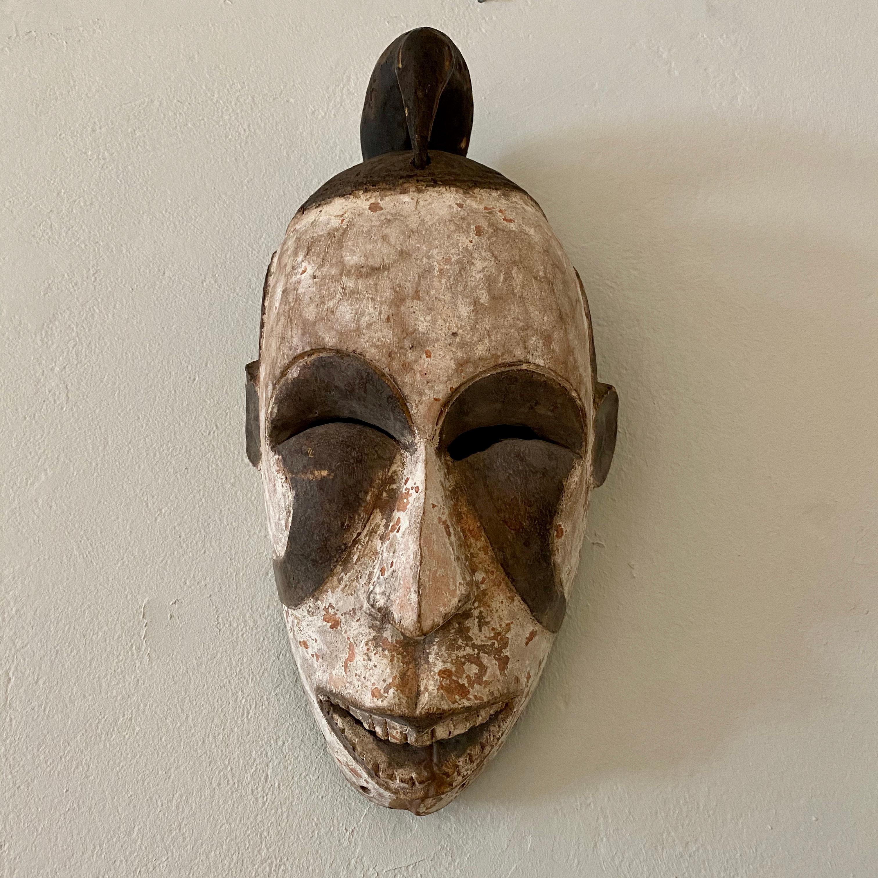 Mid-Century Modern Midcentury African Kpelie Mask Senufo Tribe Ivory Cost with a Calao Bird, 1950