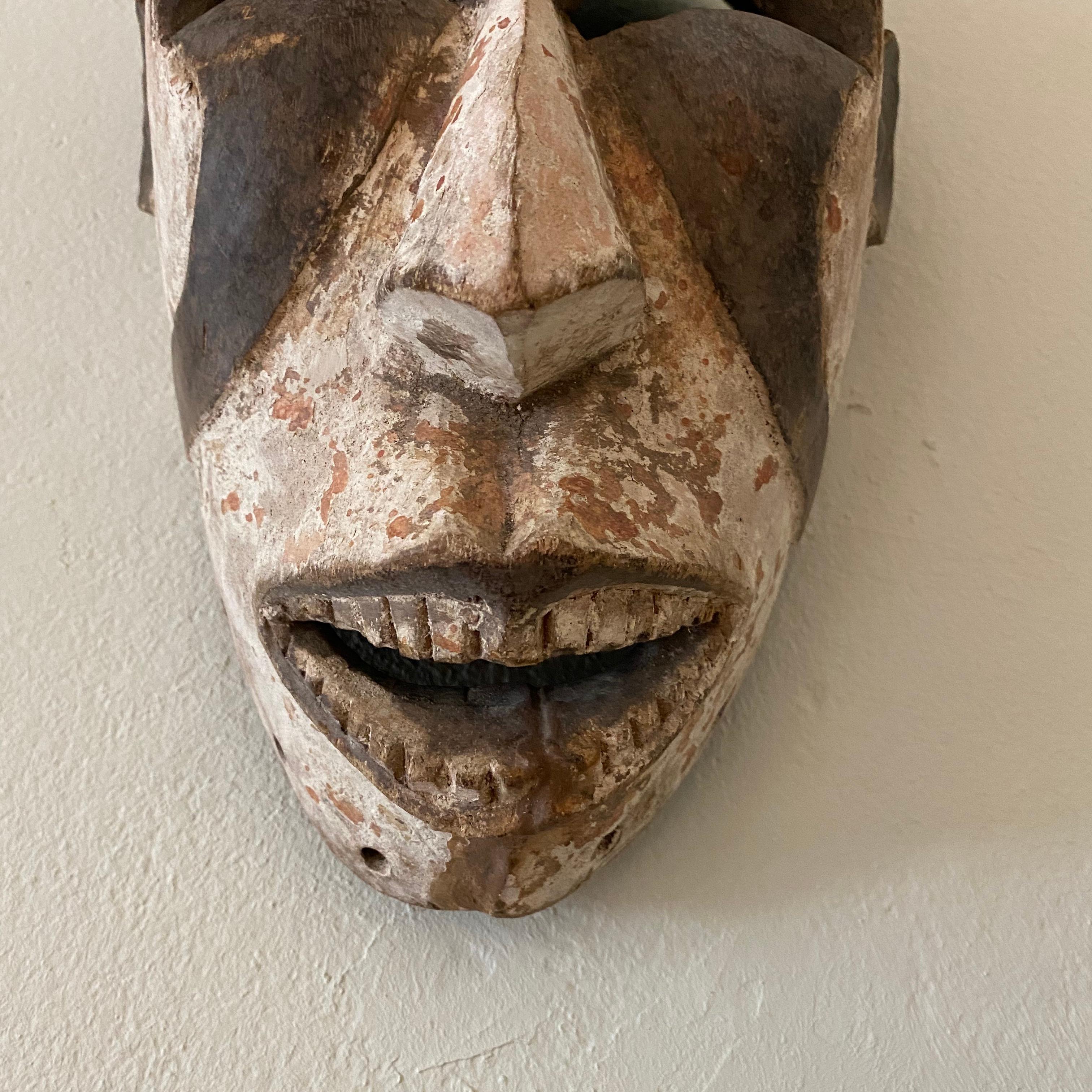 Ivorian Midcentury African Kpelie Mask Senufo Tribe Ivory Cost with a Calao Bird, 1950