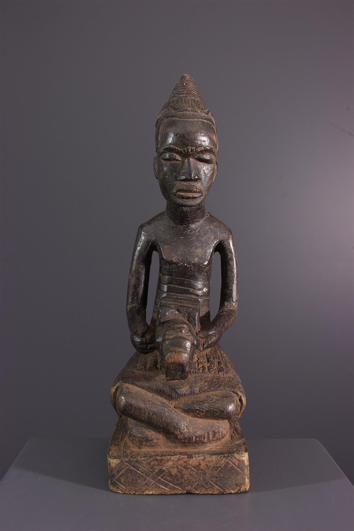 Embodiment of the king in African Kuba art sculpture. 
Of divine origin for his subjects, the king is represented sitting cross-legged on the royal
platform, unable to touch the ground. As head of the kingdom and of the Bushoong chieftaincy,
