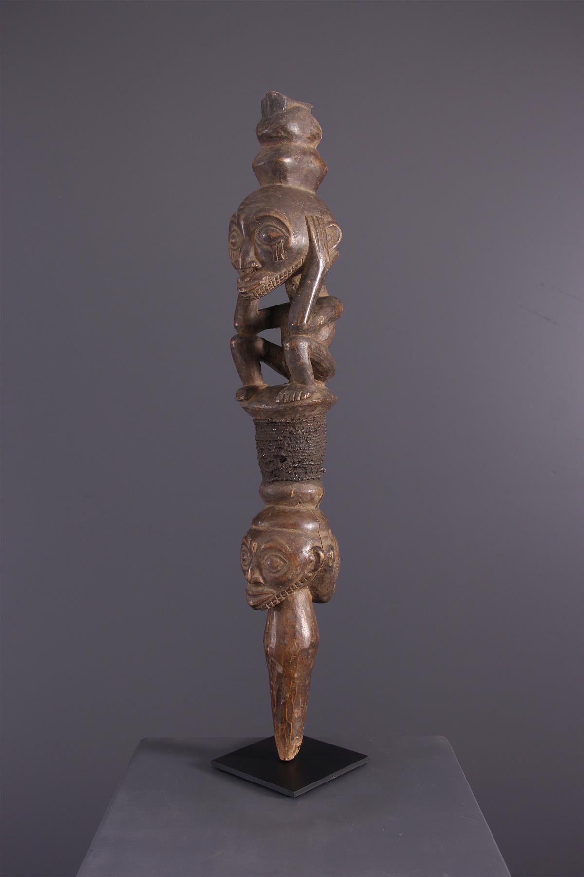 Kusu command rod
This prestigious staff among chieftain regalia is composed of different carved sections that form an iconographic language related to the history of the ancestor or his clan, like the kibangos of the Luba. 
Wrapped around the