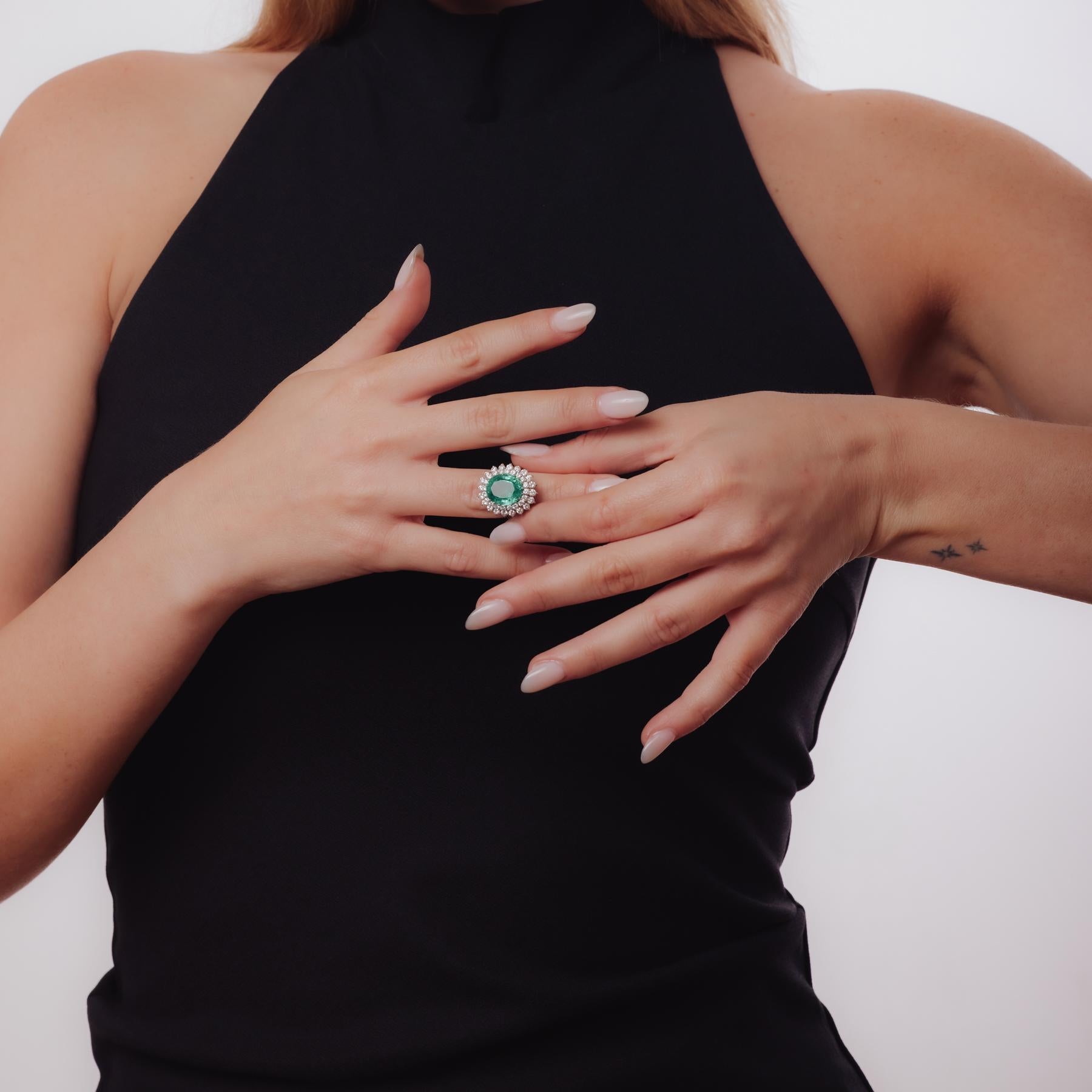 Certificate: AGL #1111627
Center stone: Oval cut emerald
Weight: Approximately 6 carats
Origin: Colombia
Treatment(s): Minor oil
Accent stone: 40 round brilliant cut diamonds
Weight: Approximately 1.60 carats
Color: F-G
Clarity: VS
Metal: 18k white