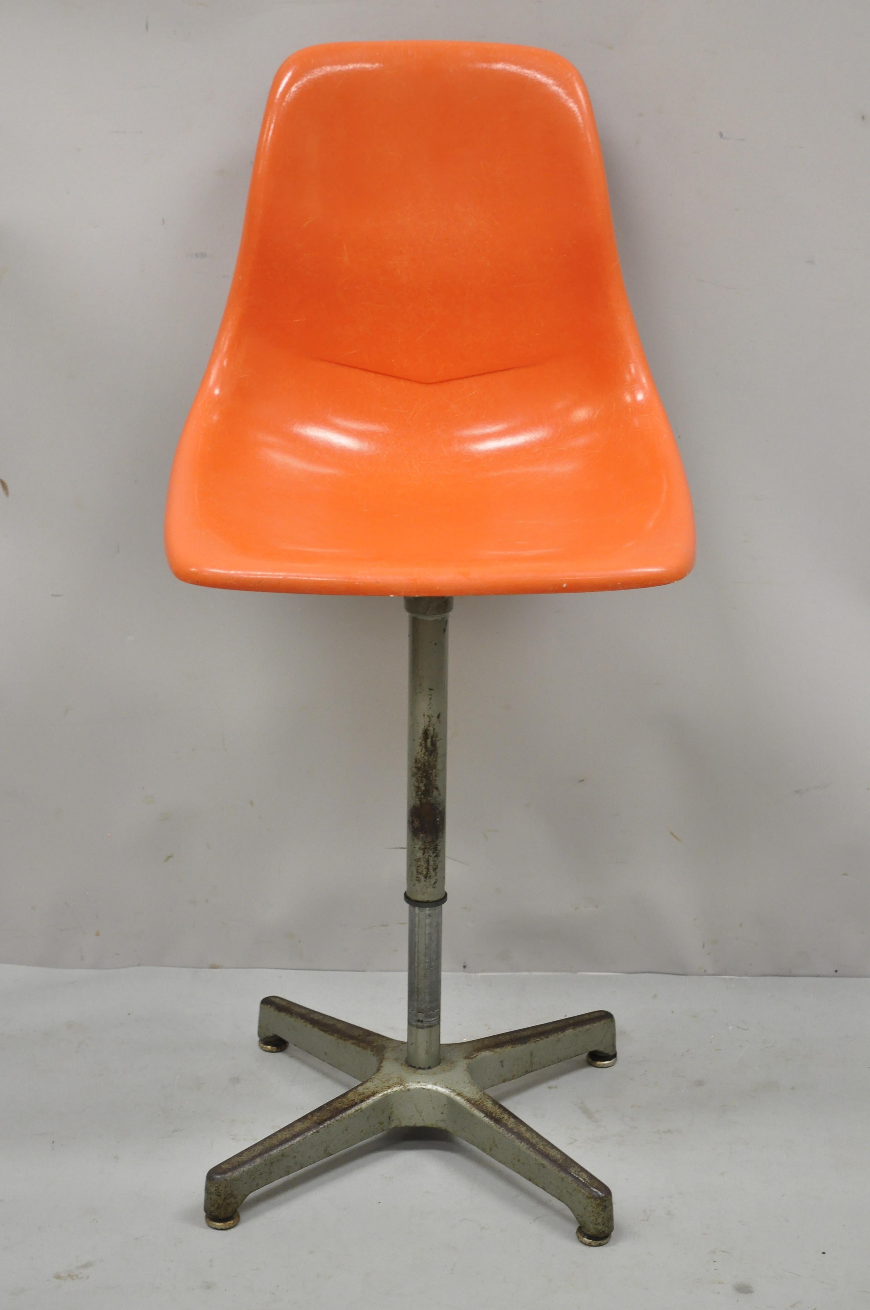 Vintage Mid-Century Modern Ajustrite orange fiberglass shell Eames style adjustable chair stool. Item features orange molded fiberglass shell seat, adjustable height base, original label, very nice vintage item, quality American craftsmanship, great