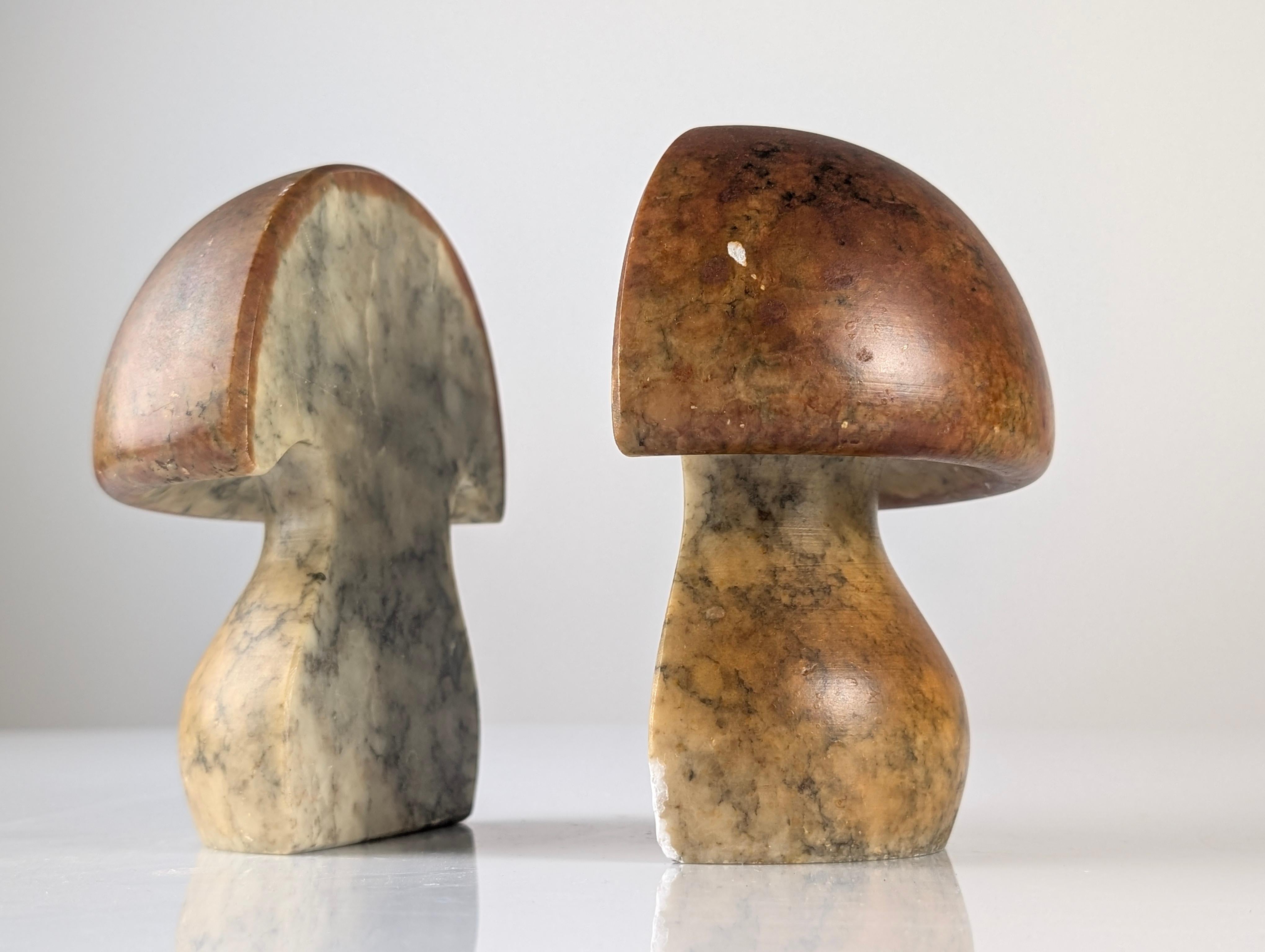 Pair of sculptural mushroom-shaped bookends, handcrafted in Italy from natural alabaster during the 1960s, exemplifying the organic elegance of Mid-Century design. Each piece is carved from a single block of stone, showcasing refined Italian