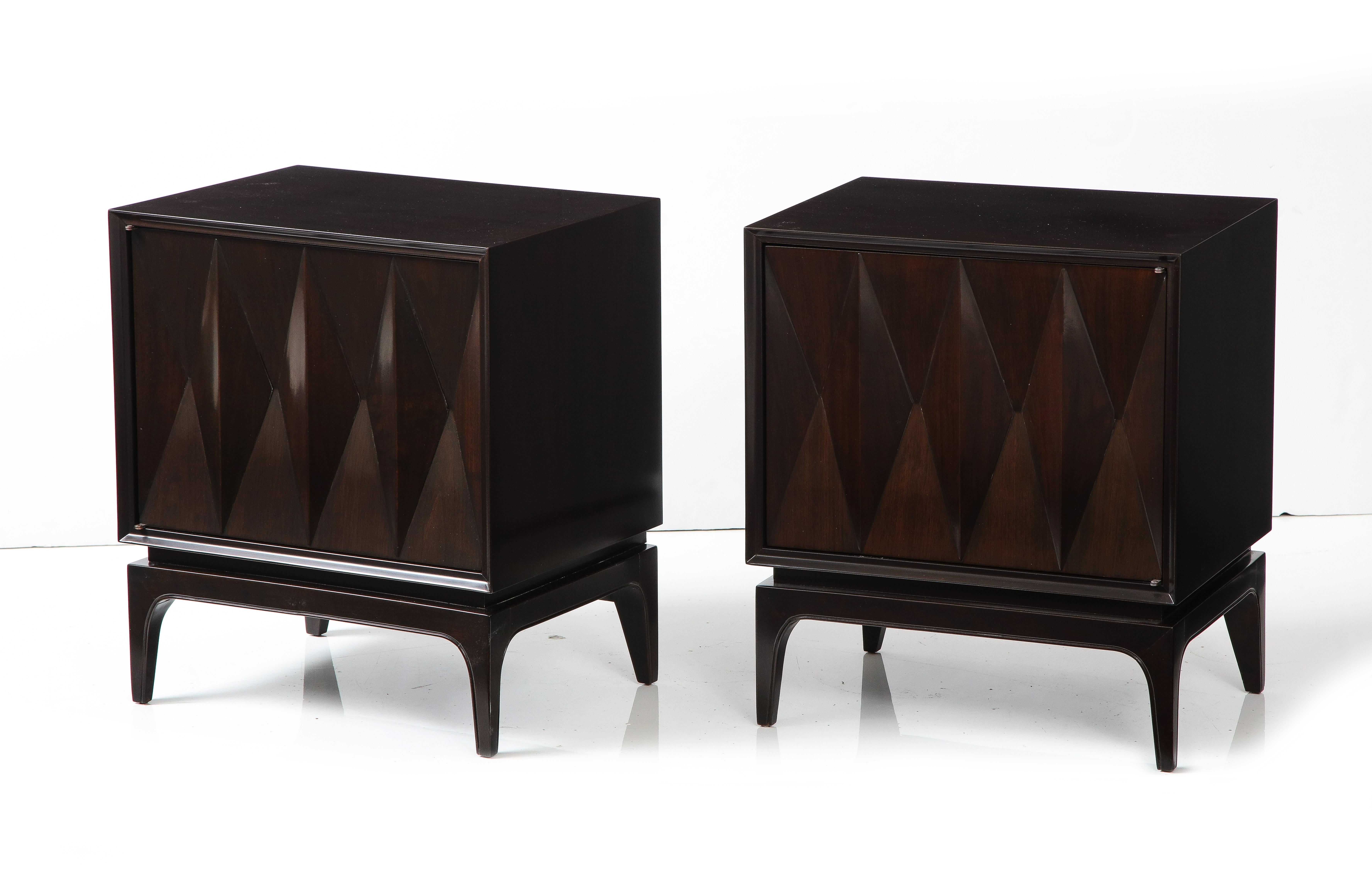 Pair of midcentury dark brown stained Walnut night stands featuring a deep carved cheveron pattern on doors, which open to reveal a single drawer and compartment. Mint Restored.