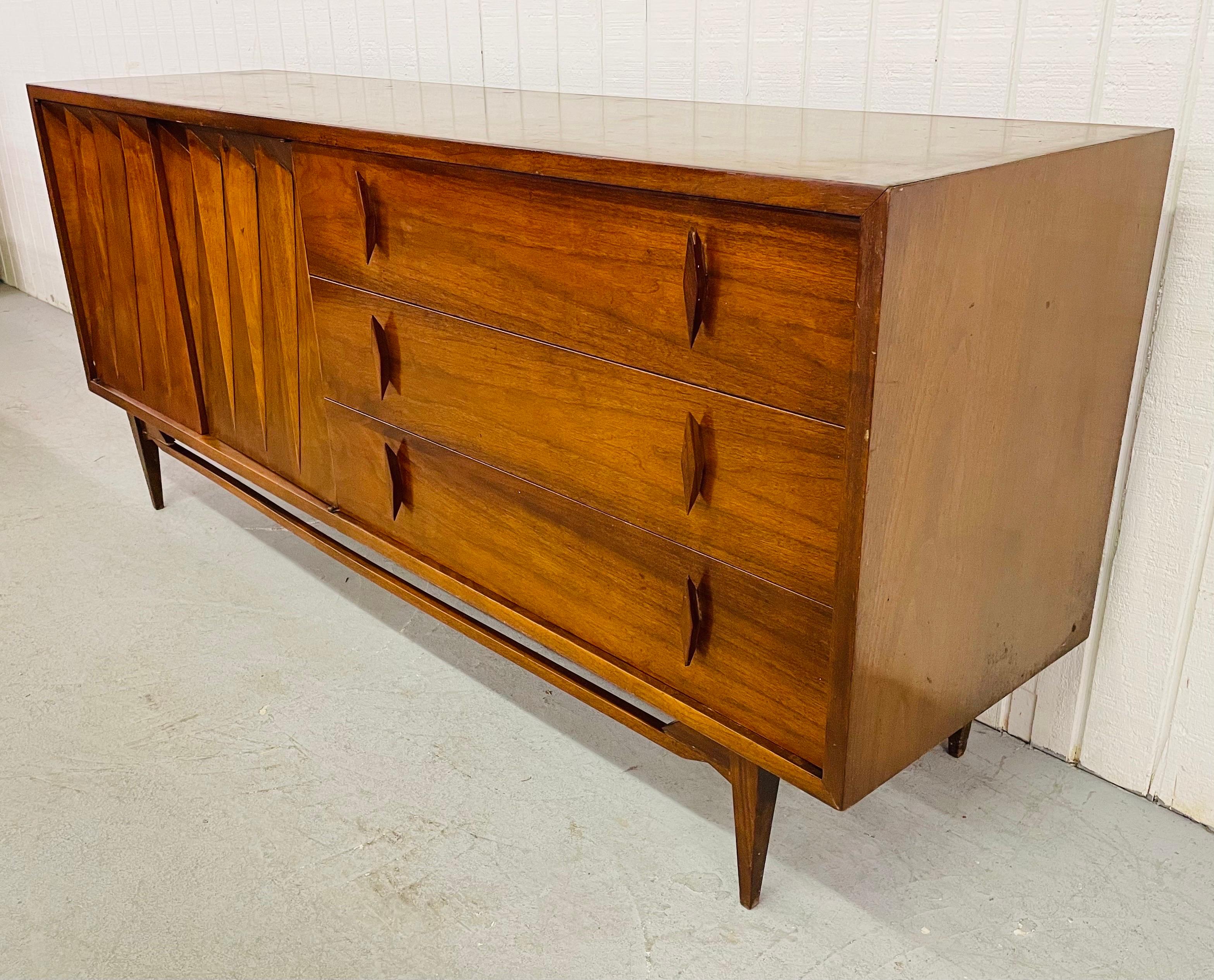 This listing is for a Mid-Century Albert Parvin Walnut Dresser. Featuring two diamond shaped doors on the left that open up to three hidden drawers, three drawers on the right with original diamond shaped walnut pulls, and a beautiful walnut finish.