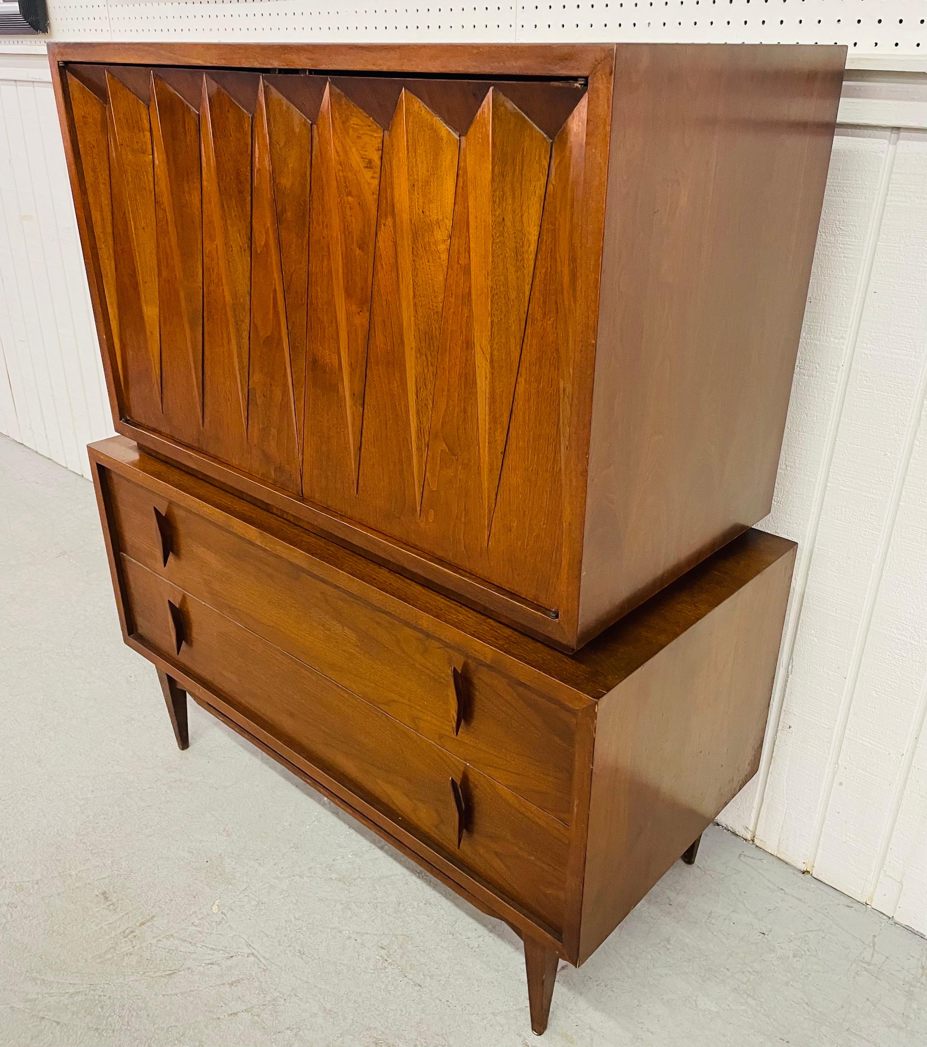 This listing is for a Mid-Century Albert Parvin Walnut High Chest. Featuring a chest on chest design, two diamond shaped doors that open up to three hidden drawers, two drawers at the bottom, original diamond shaped walnut pulls, and a beautiful