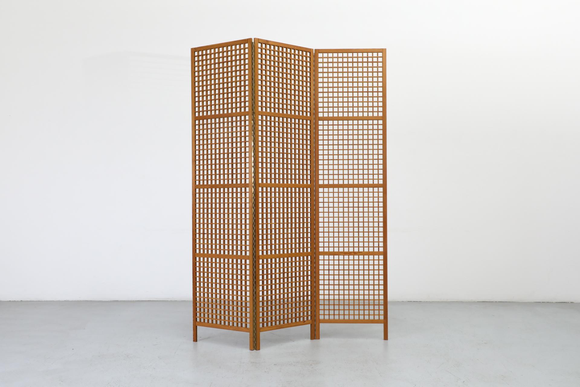 Mid-Century Alberts Tibro style room divider or privacy screen. Folding, 3 section, pine wood screen with attractive grid pattern and full length brass hinges. In original condition with wear consistent with age and use.