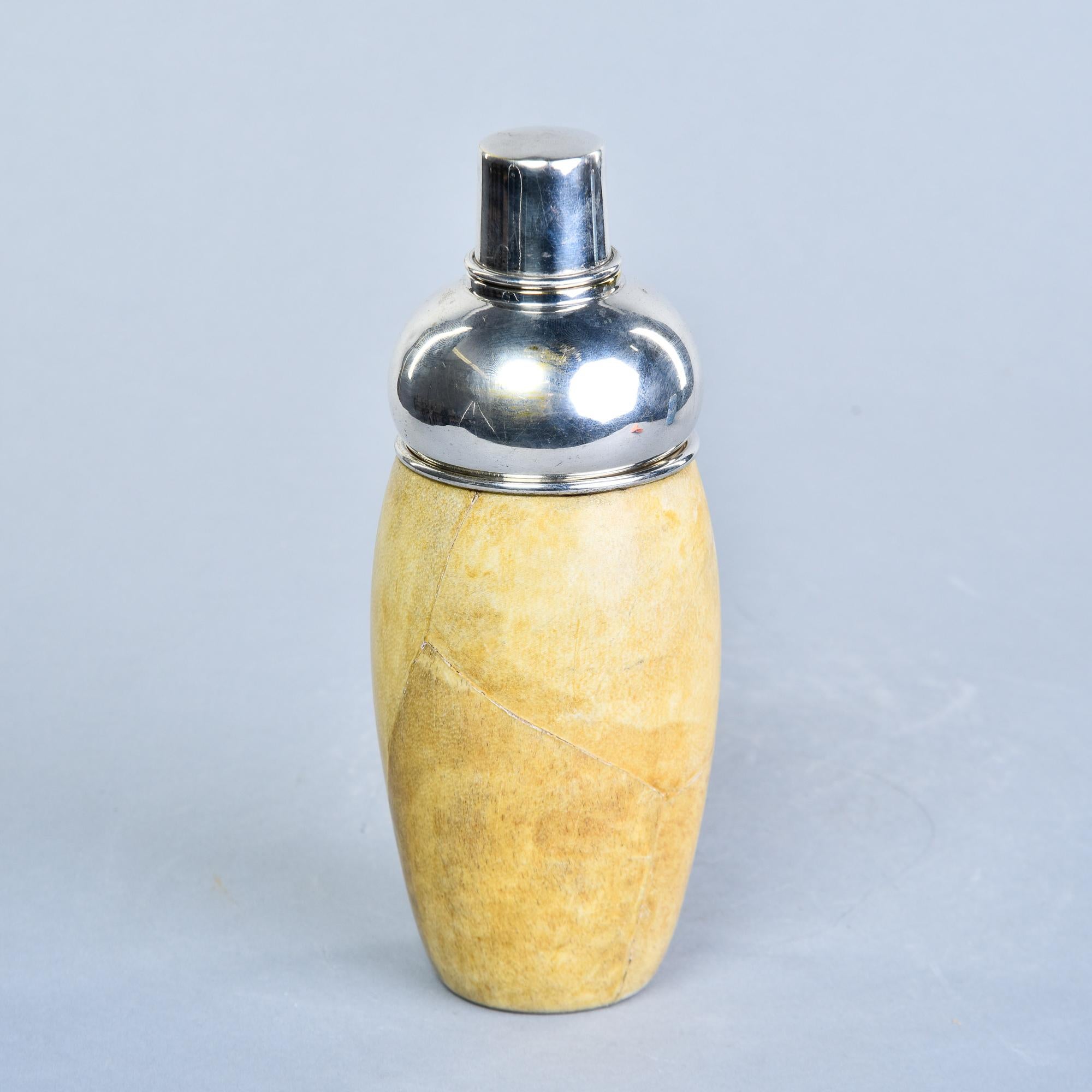 Found in Italy, this Aldo Tura cocktail shaker dates from the 1950s. The shaker body is a goatskin leather-clad wood shell with a stainless steel inner liner. Removable steel top and strainer. Leather has great age-related color. Very good overall