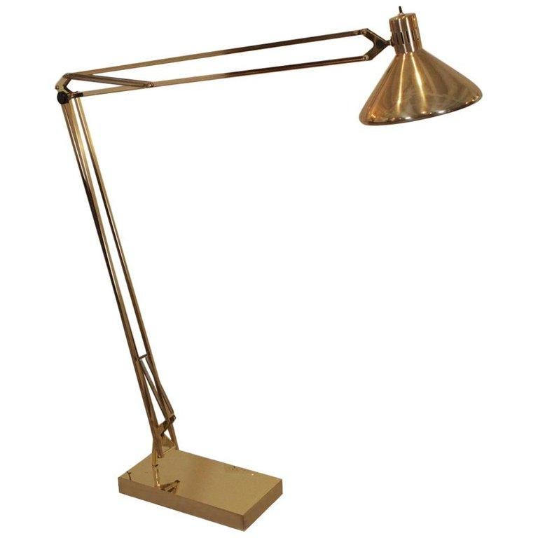 This midcentury swing arm floor lamp by Alsy Manufacturing Company features brass construction and adjustable height and reach. Base is nice and stable even when fully extended. Black mark on base as shown in photo, can be polished out.