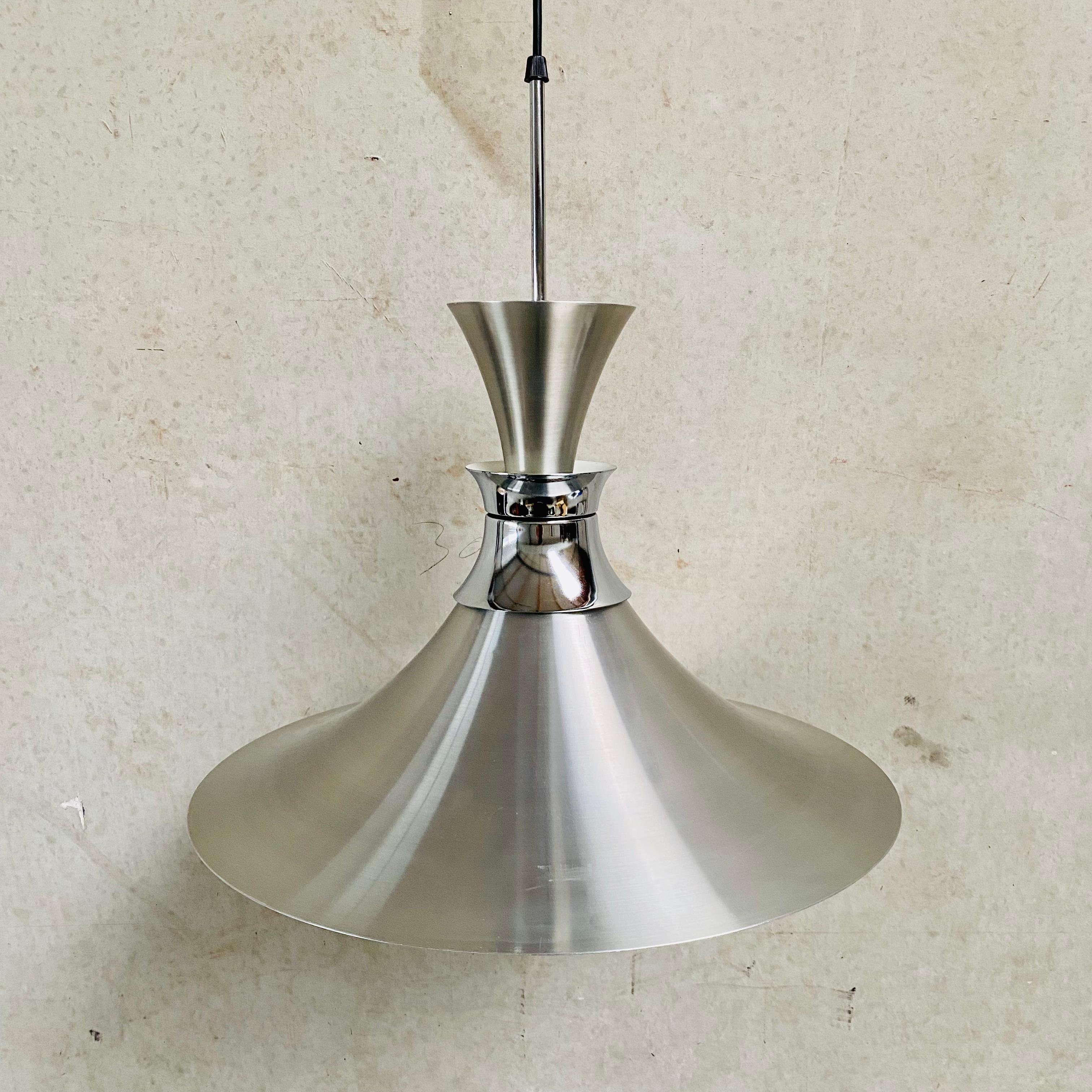 Introducing the midcentury Aluminium Pendant by Bent Nordsted for Lyskaer Denmark 1970. This remarkable pendant light embodies the essence of Scandinavian Modernist design, featuring a sleek and timeless aesthetic that effortlessly blends form and