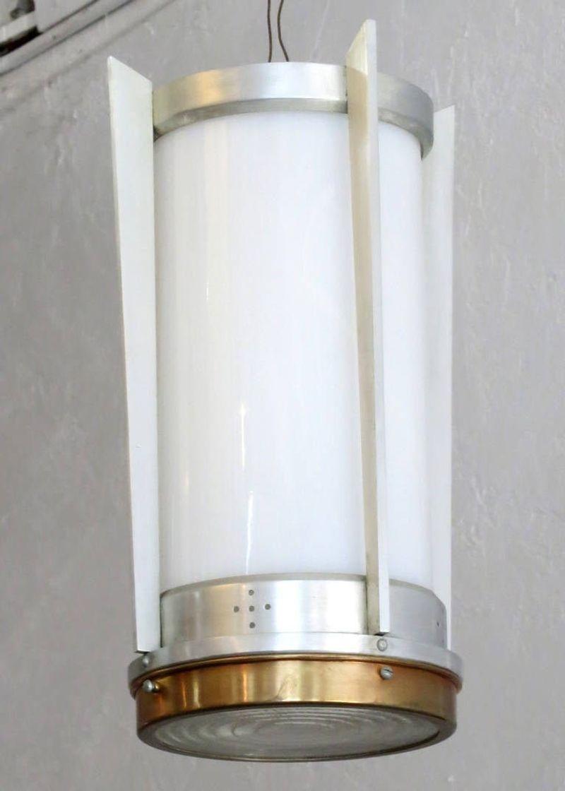 This pair of mid-century hanging lamp was manufactured during the Jet Age period of the Space Race and America's obsession with speedy flight and reaching to the stars.

It shows all the hallmarks of its era with a hand-machined aluminum body and