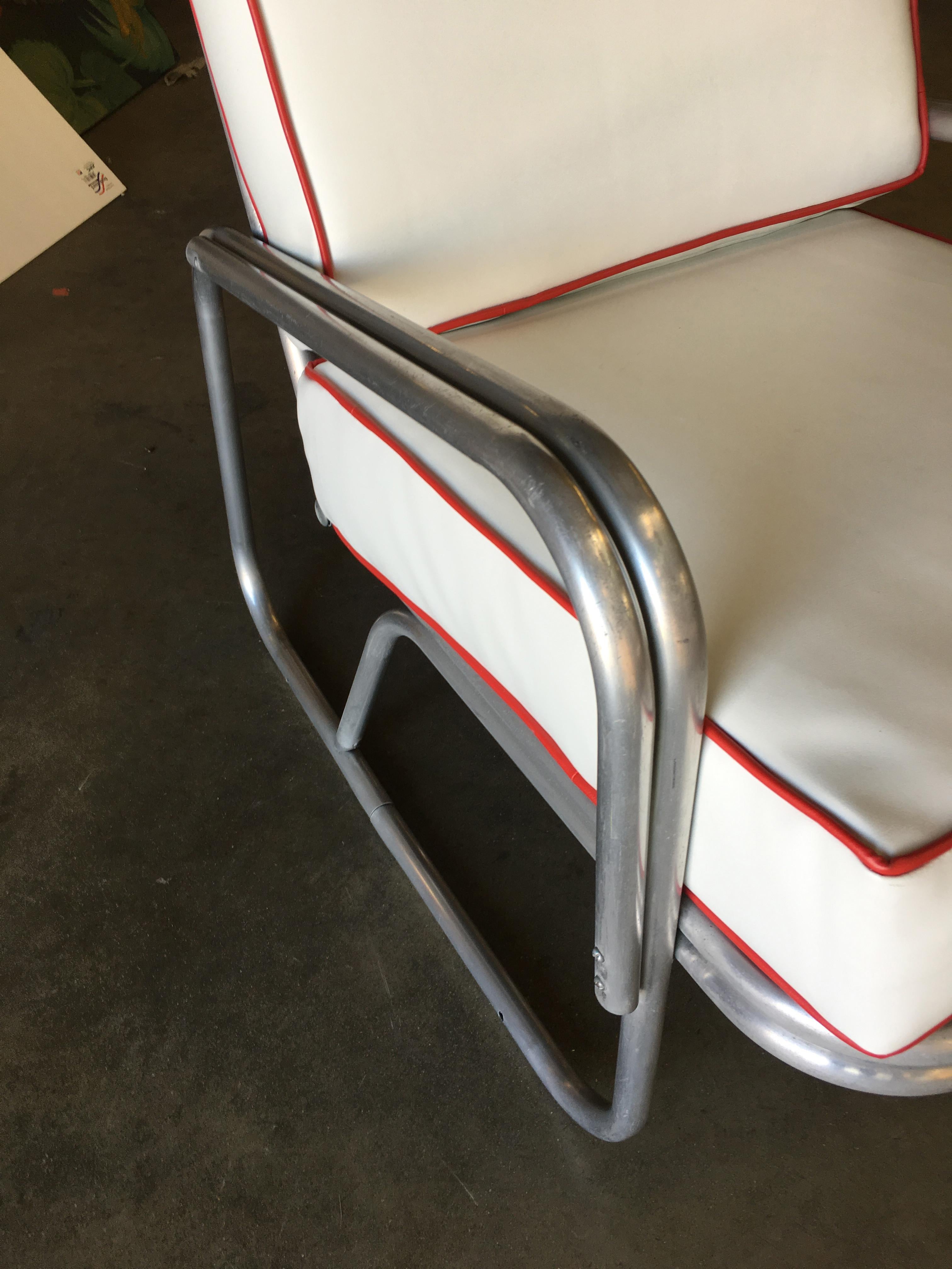 Midcentury patio/outdoor lounge chair consisting of an aluminum frame with a large sled shaped legs, circa 1950.