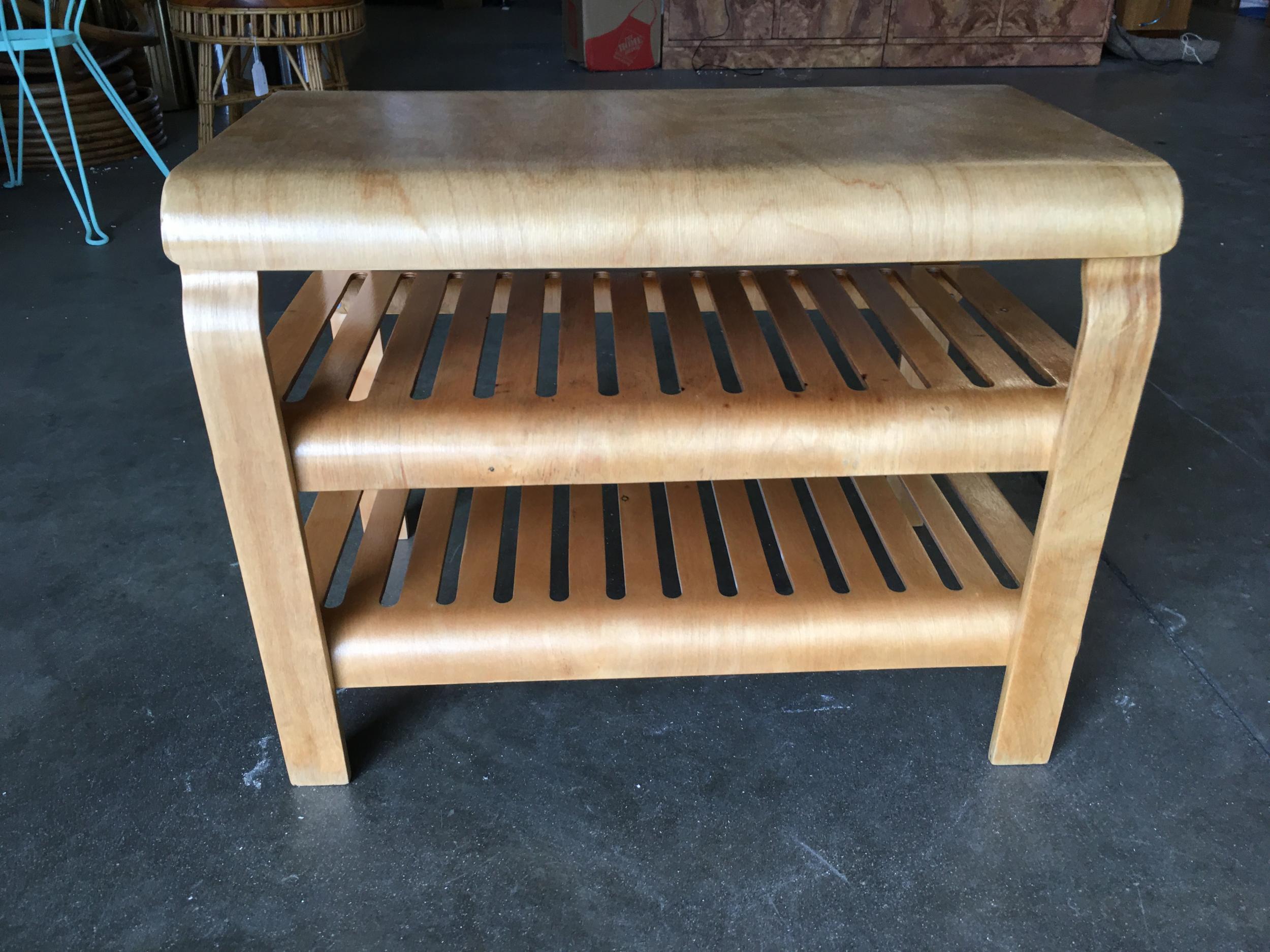 Midcentury era 3-tier blond bent plywood side table fashioned after the designs of Alvar Aalto. The table features a waterfall top and 2 vented shelves underneath.