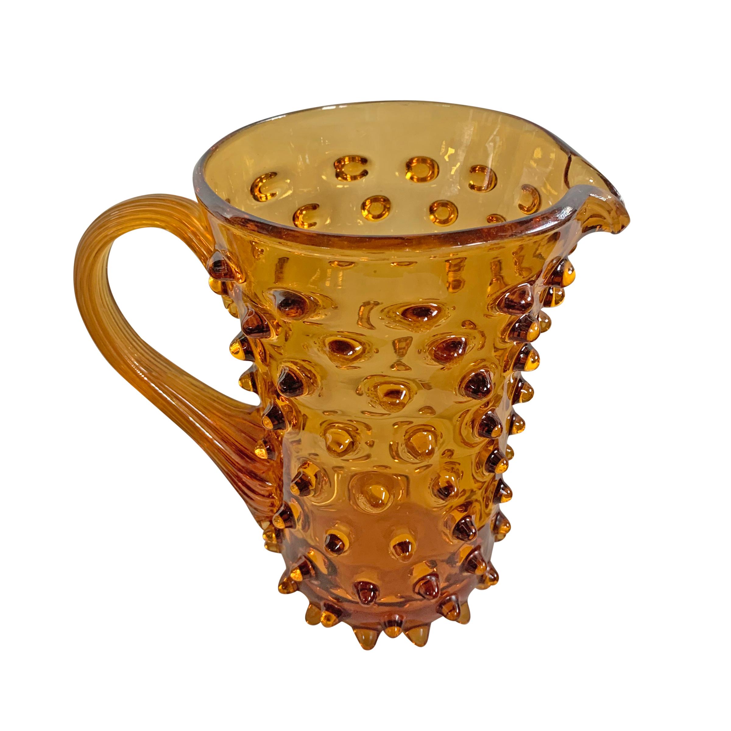 A fantastic hand blown mid-20th century American amber glass pitchers with an all-over hobnail design, and a wonderful pulled glass handle.