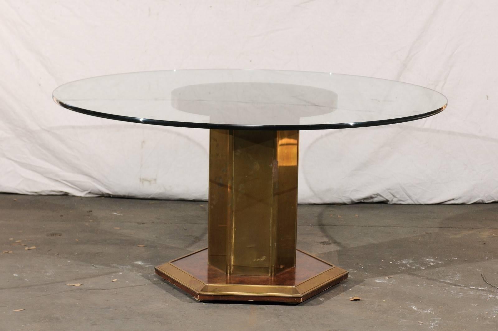 Mid-20th Century circa 1970s American brass and burled wood pedestal round glass dining table. Brass is aged.