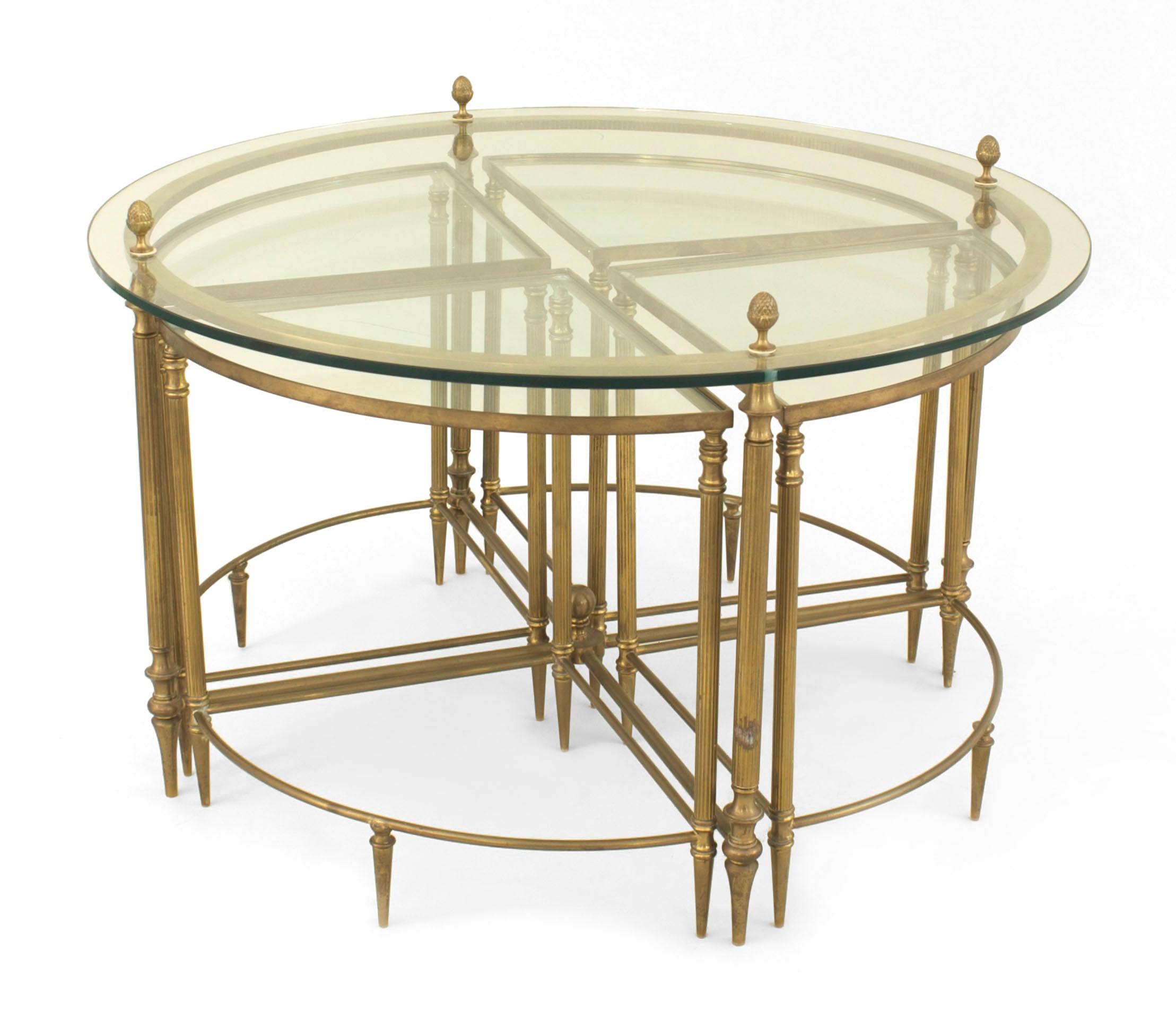 American Mid-Century brass round coffee table with a glass top with acorn finials and a lower stretcher which fits four small wedge-shaped glass top tables.
