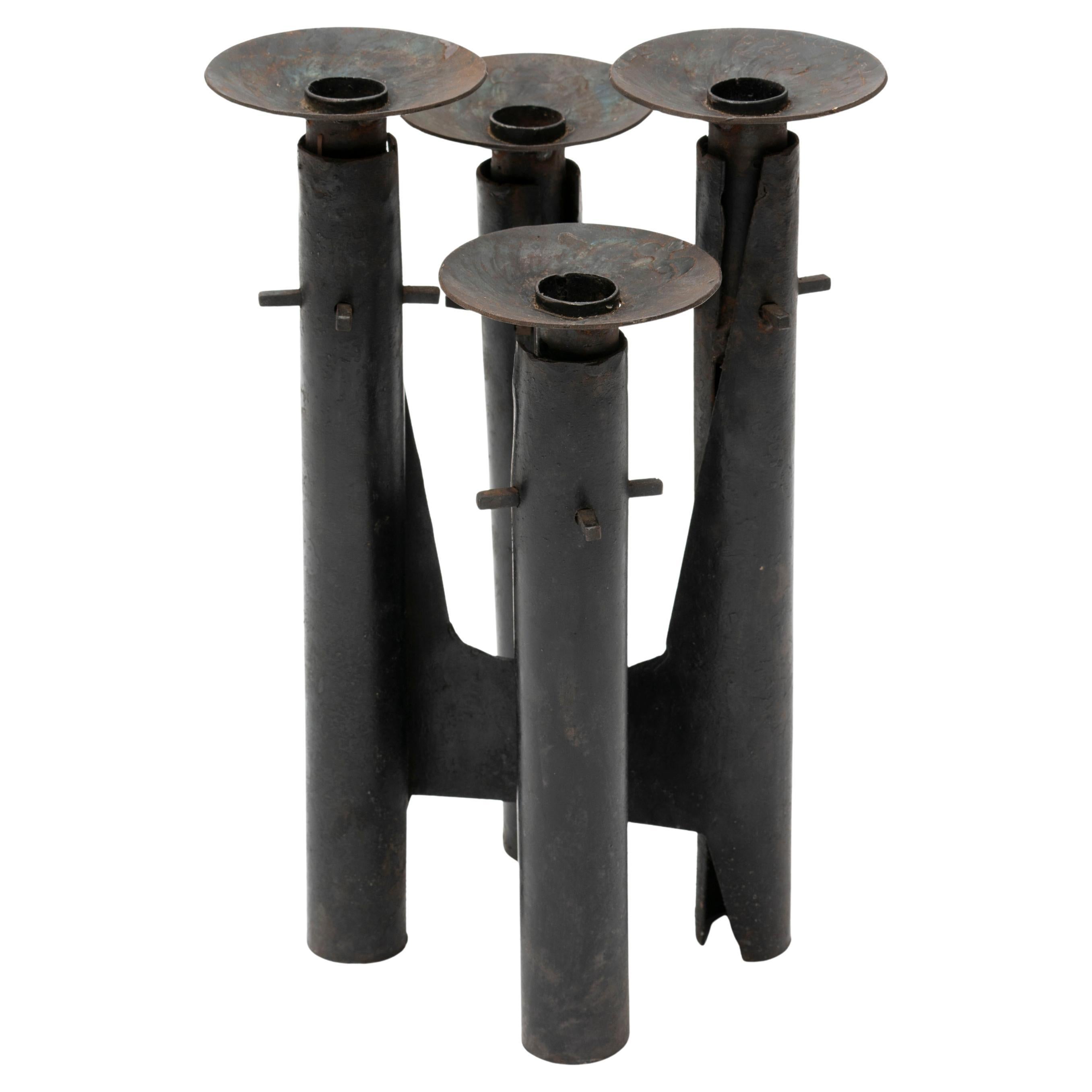 Forged metal candelabrum in the style of Paul Evans. It comes with 4 staggered holders for candles at different heights. 
 
Unique and well-made item. 