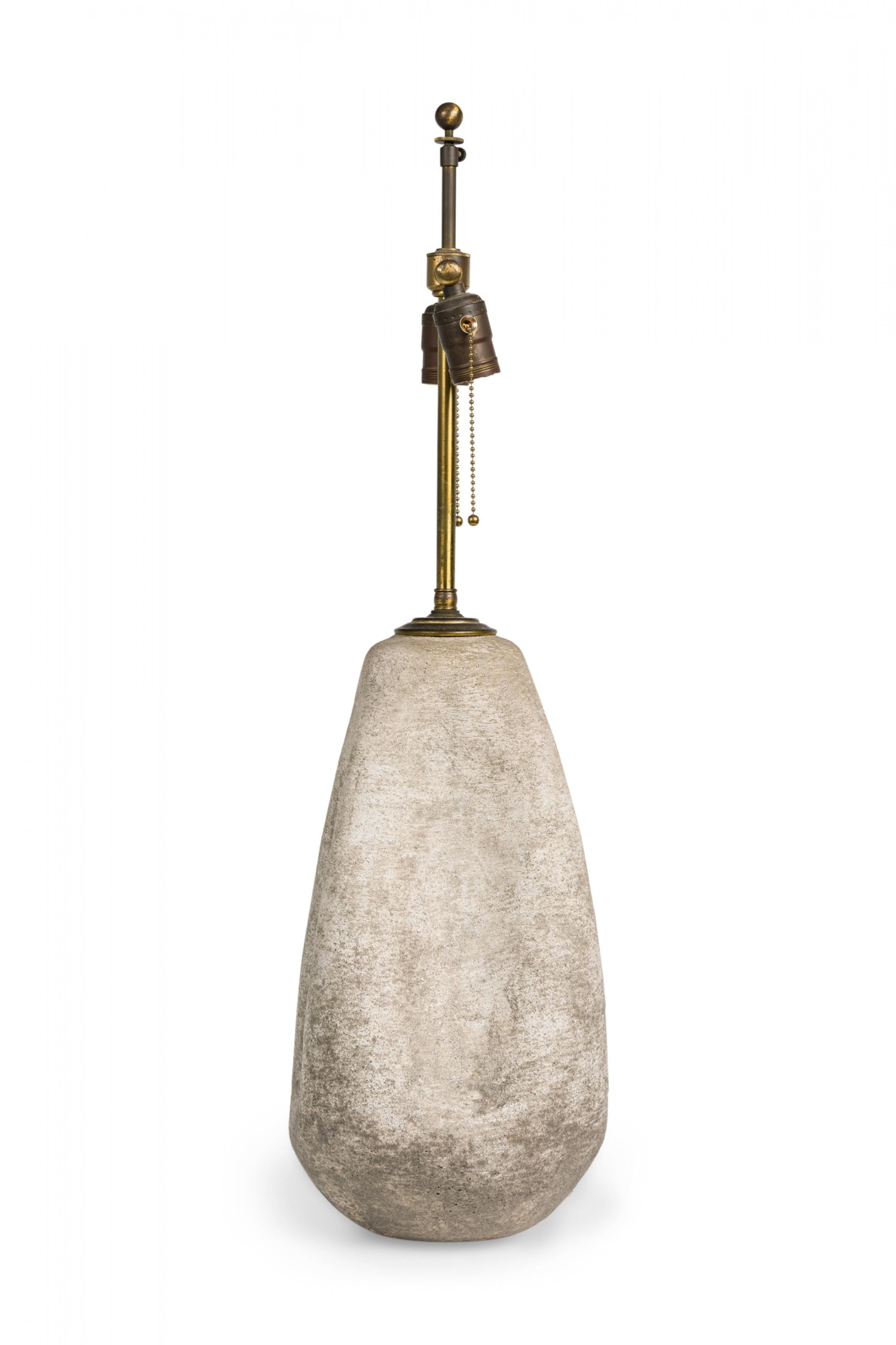 Mid-Century American ceramic table lamp horizontally textured and fired in a white chalk glaze, in pinched tapered gourd form, topped by a brass stem and ball finial, two functioning light sockets with beaded pulls plus an on / off switch attached