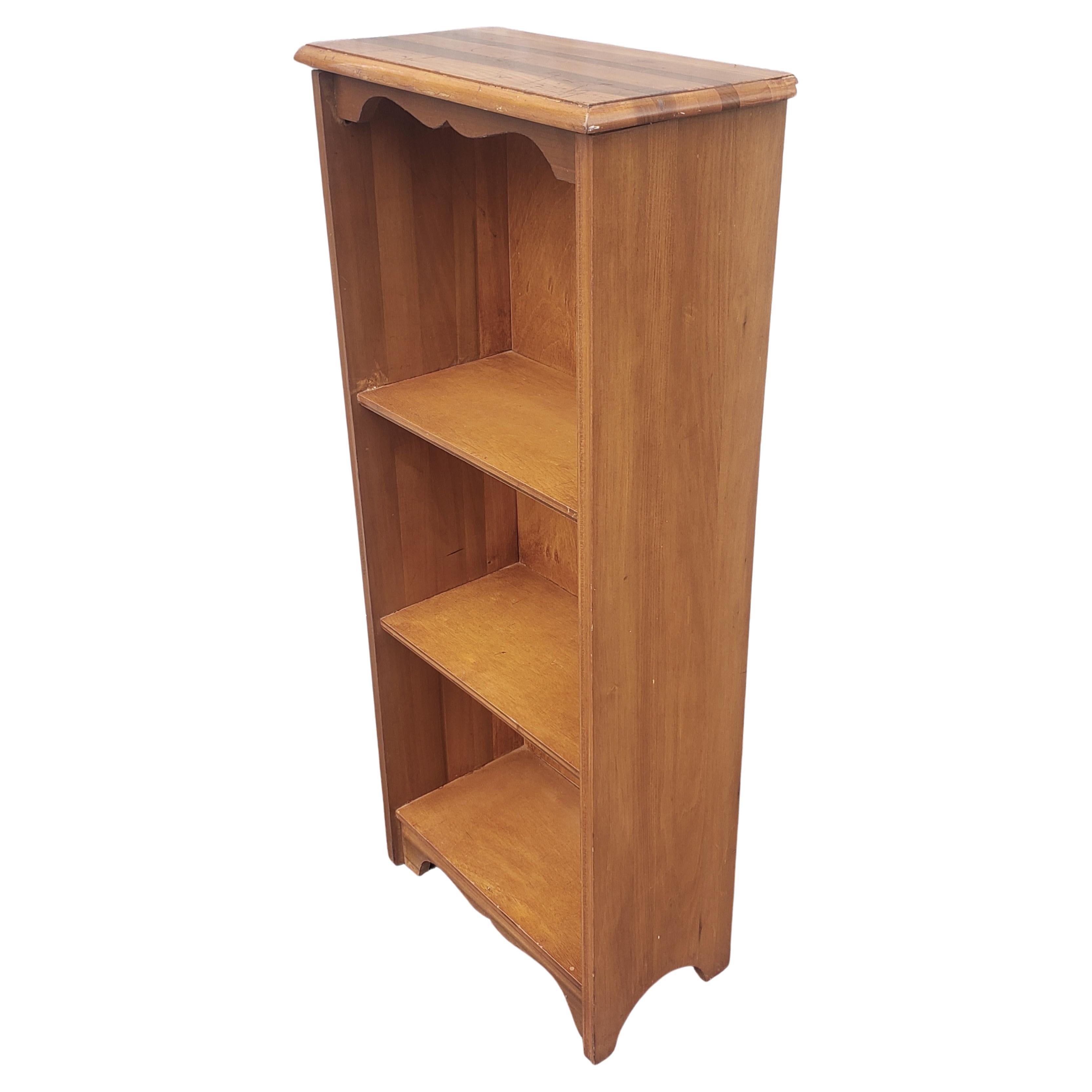 A midcentury American Classical Three Tier Light Cherry Narrow Bookcase in great structural condition. 
Measures 18