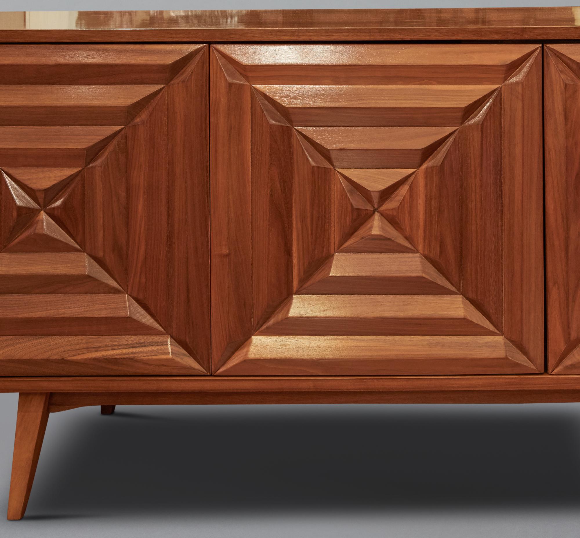 American hardwood console with compartments, drawers and shelves on tapered feet.