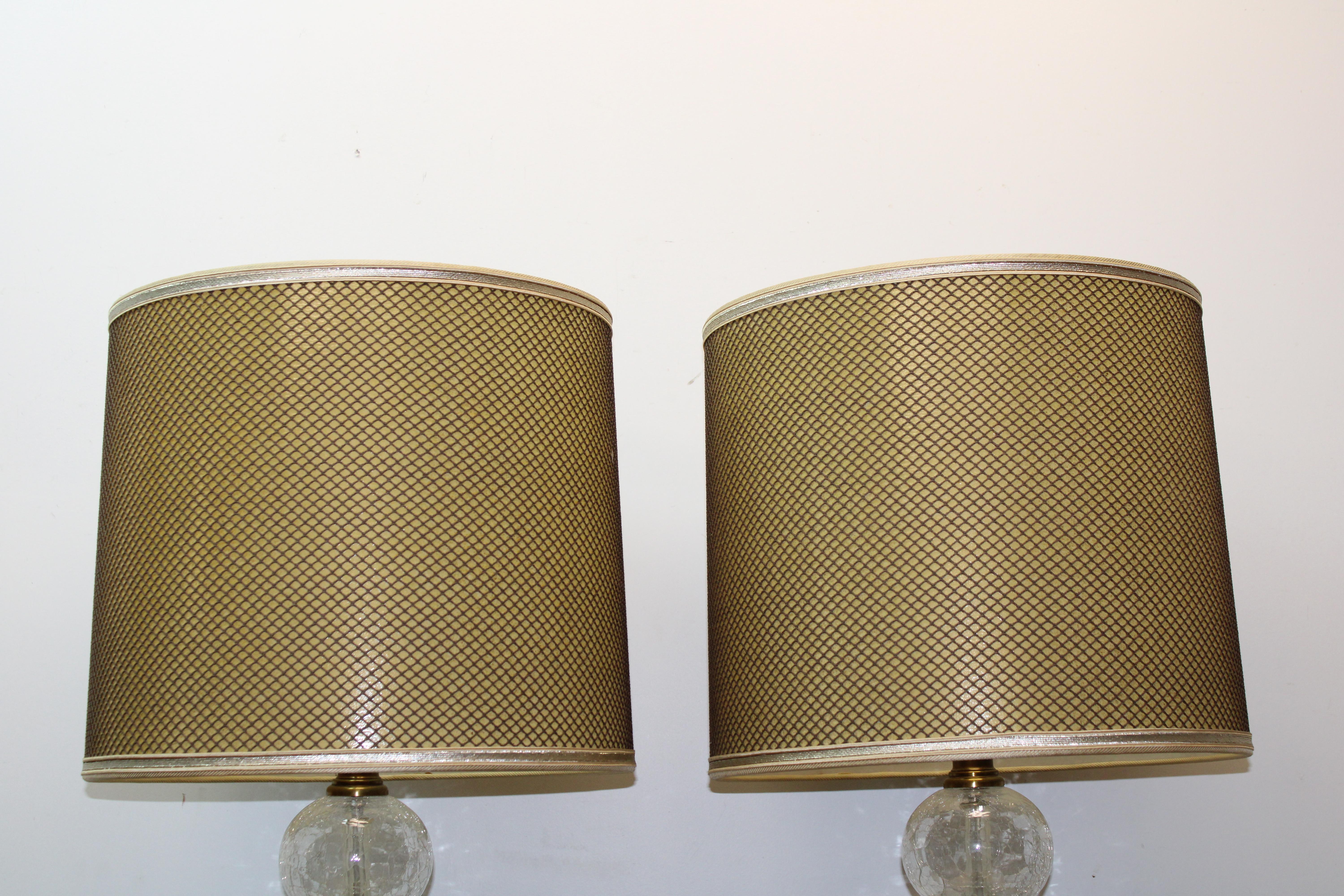 C. 20th century

Pair of mid century American clear crackled glass lamps By Paul Hanson

Lamps consist of 4 stacked clear crackled glass spheres w/ brass dividers on a circular base.