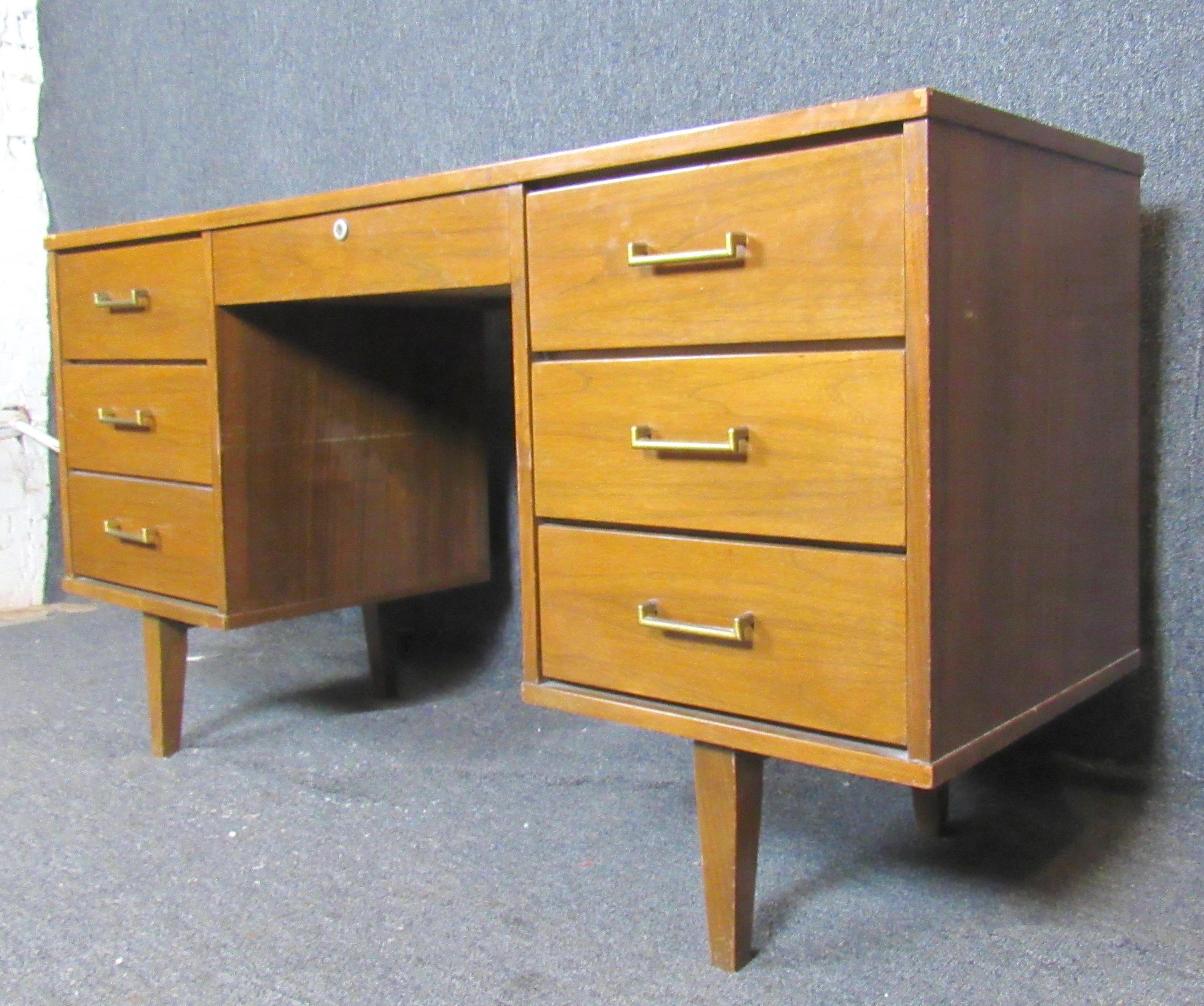 Double pedestal mid-century desk with laminate top. Six total drawers for storage and finished wood back.
Please confirm location.