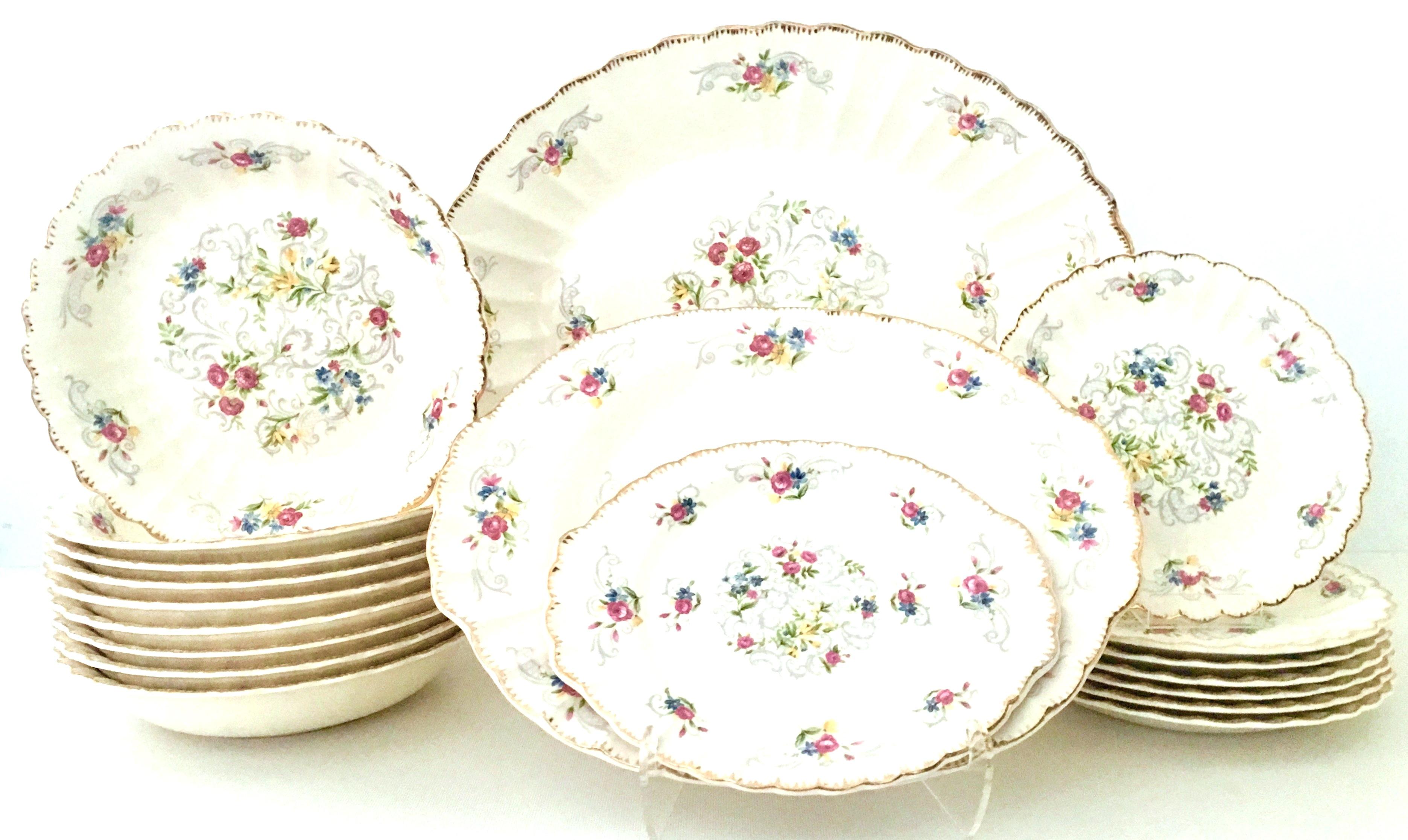 Mid-Century American Limoges set of 19 pieces By, Jennie Lind. Pattern features an off-white ground with hand-painted filigree 22-karat gold edge and a vibrant with muted gray scroll floral pattern. Each piece is signed on the underside, Made In The