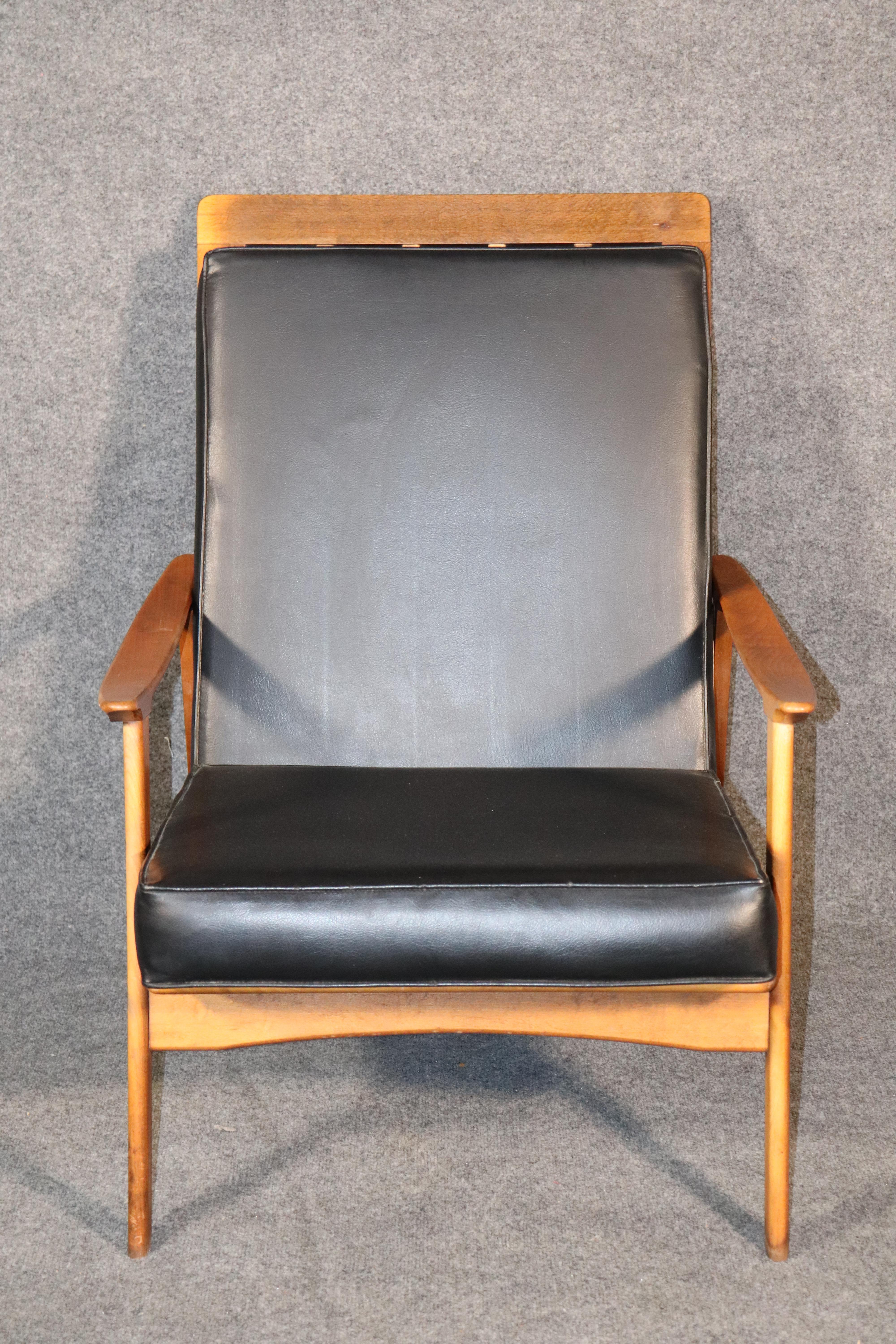 Vintage modern armchair with high back. Two cushions sit on a walnut frame lounge chair with scooping arms.
Please confirm location.