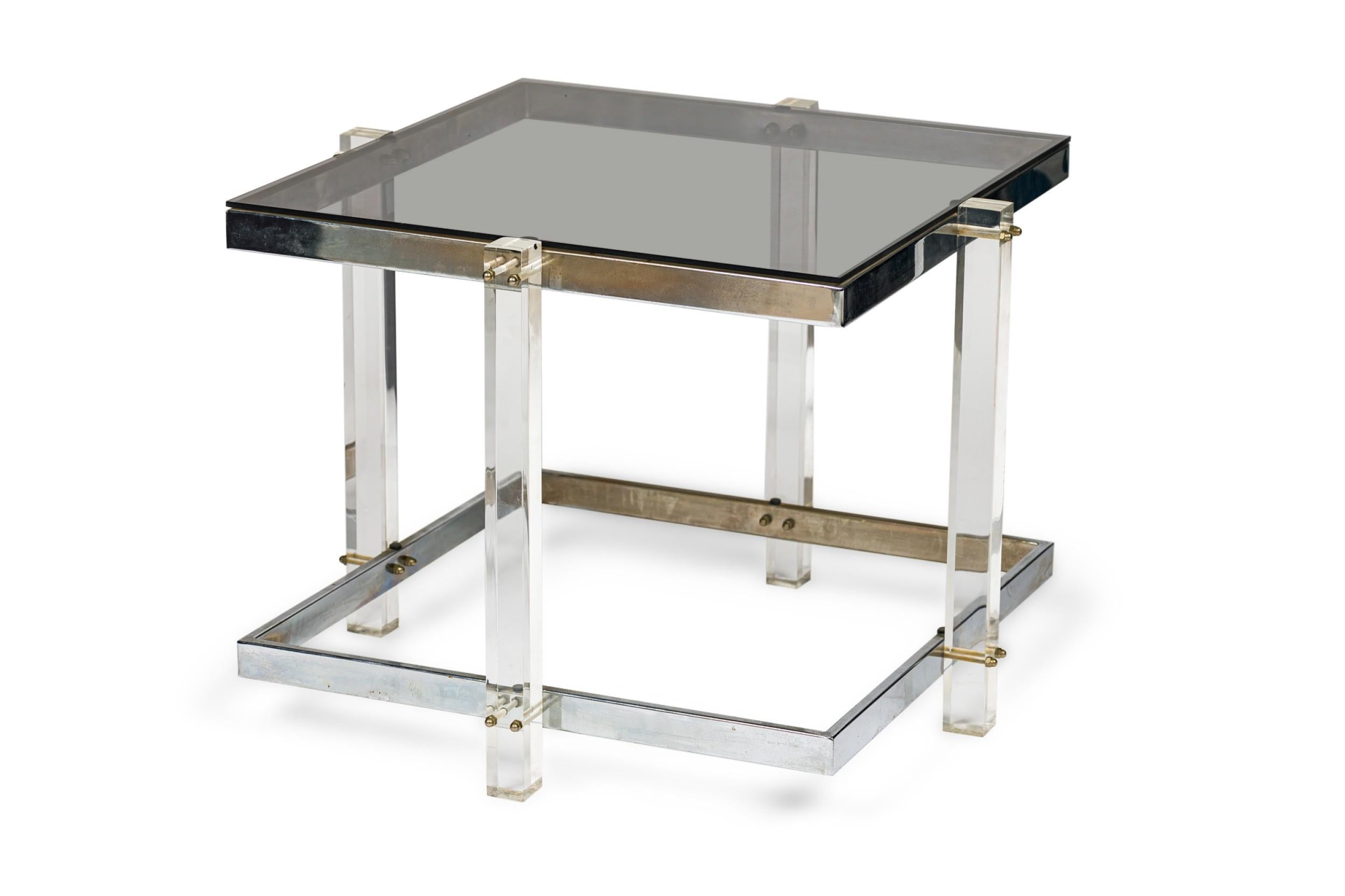 Mid-Century American Modern lucite and chrome rectangular glass topped coffee /end table in minimalist geometric form with a second lower shelf for optional glass placement. (in the style of CHARLES HOLLIS JONES)
 

 Condition Notes:
 Some wear to