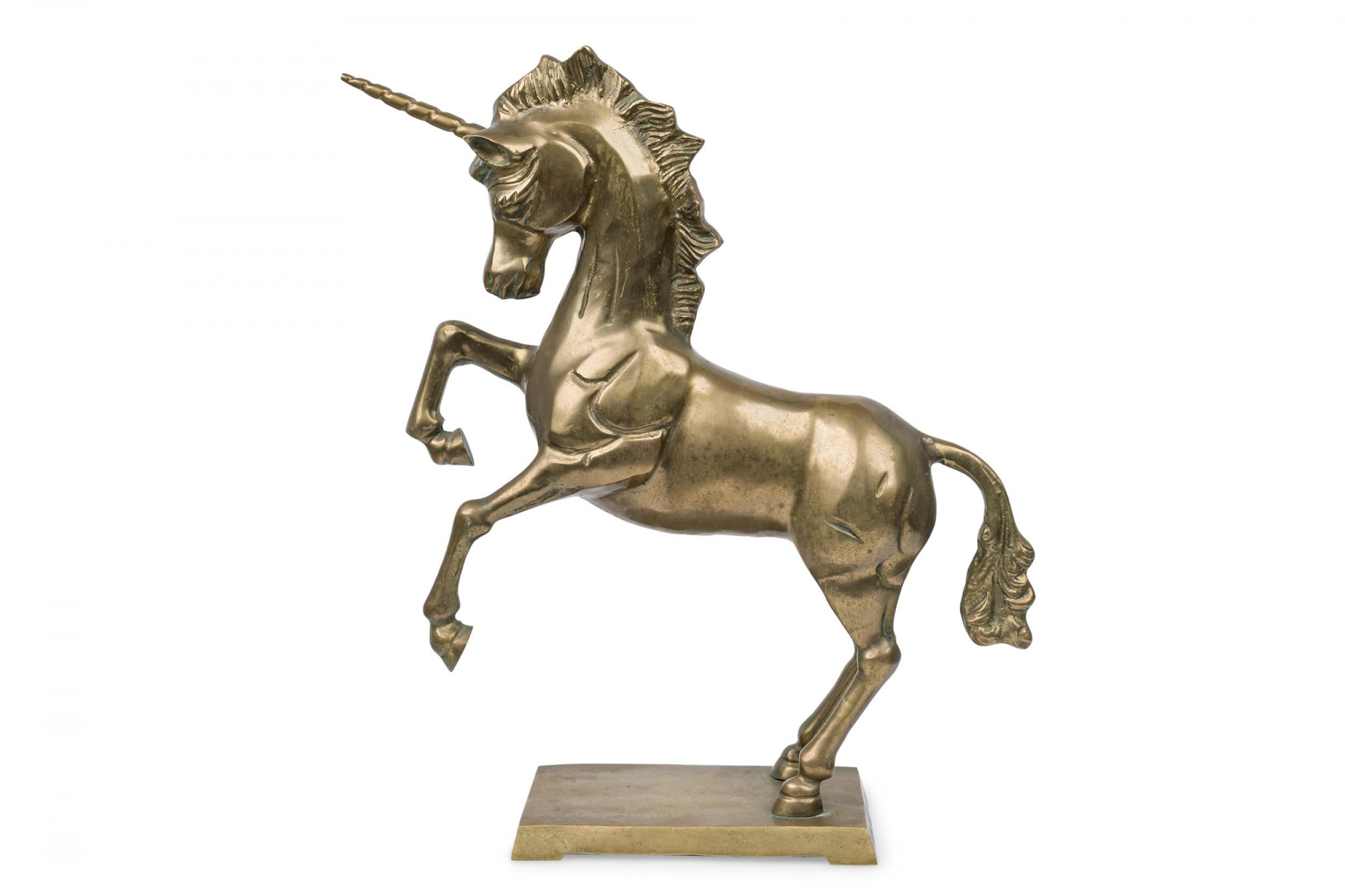 Midcentury American Modern brass sculpture depicting a unicorn in realistic style standing on its hind legs, supported on a flattened square base.